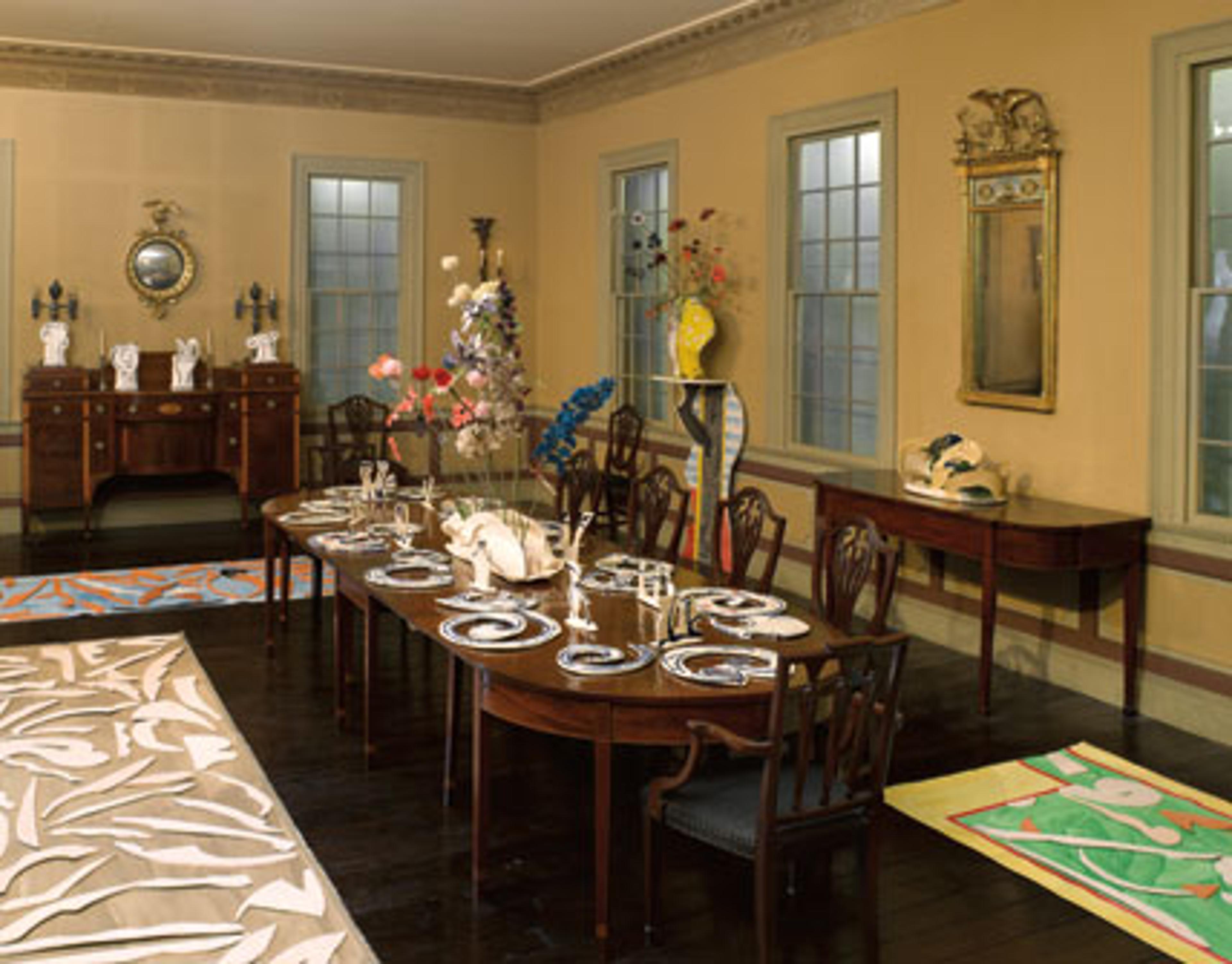 Betty Woodman (American, b. 1930). Table Setting; Wallpaper Wall Jar; Double Vase Wall Jar; andGreen Border, Blue Rug, Clay Bones, Green Rug, Turkish Carpet, Five Ceramic Carpet. Ceramic, glass, canvas. Courtesy of the artist and Salon 94 Gallery. Anne Chu (American, b. 1959).Cardinal; Painted Bunting; and Flower Drawings with Betty Woodman, No. 1, No. 2, No.3. Wire, textile, glazed ceramic. Courtesy of the artist, Matthew Goulet, and Donald Young Gallery. In Dining Room, Cane Acres Plantation, Summerville, South Carolina