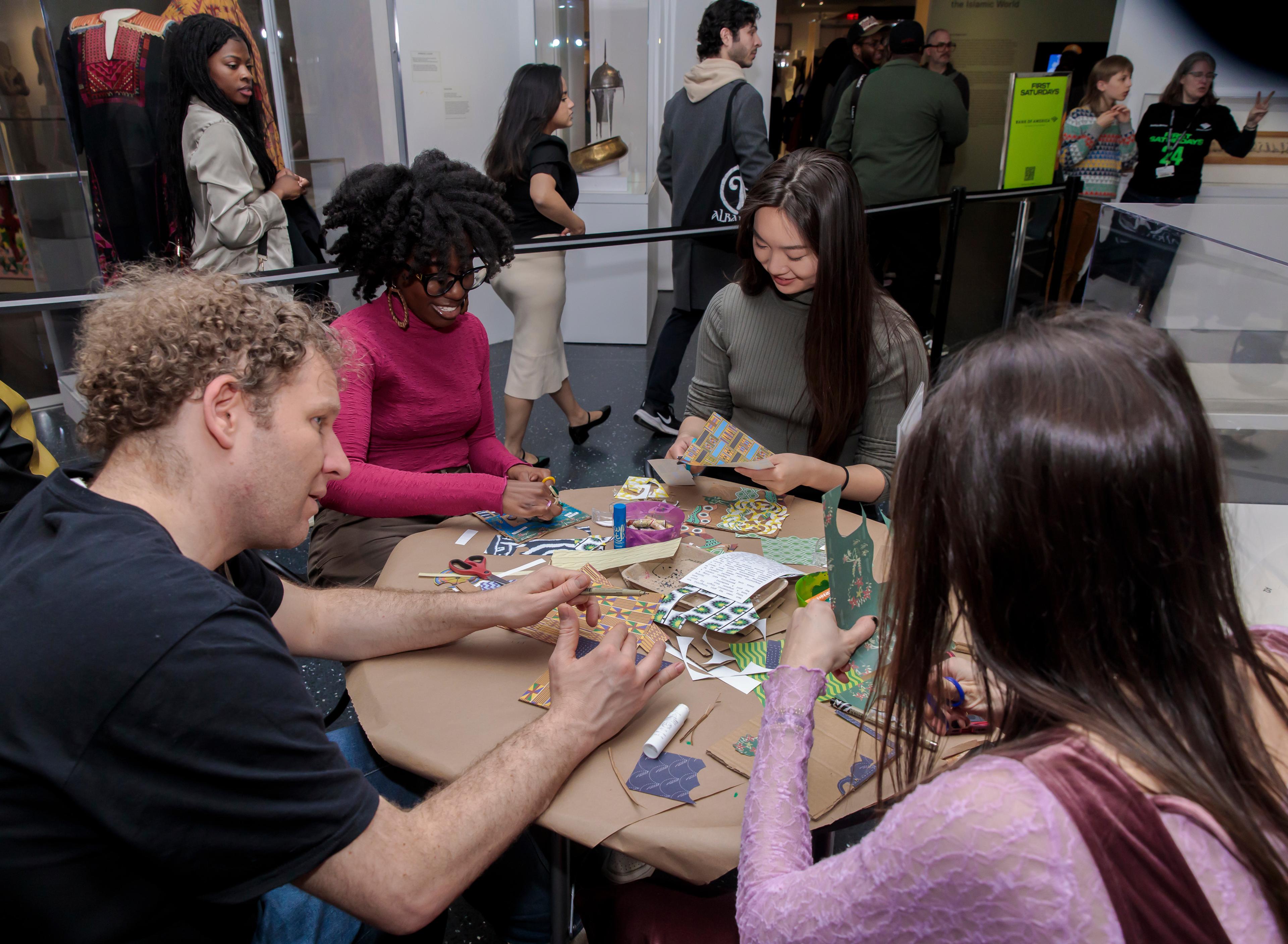 A smiling group of adults sit around a table working arts and crafts project with color paper