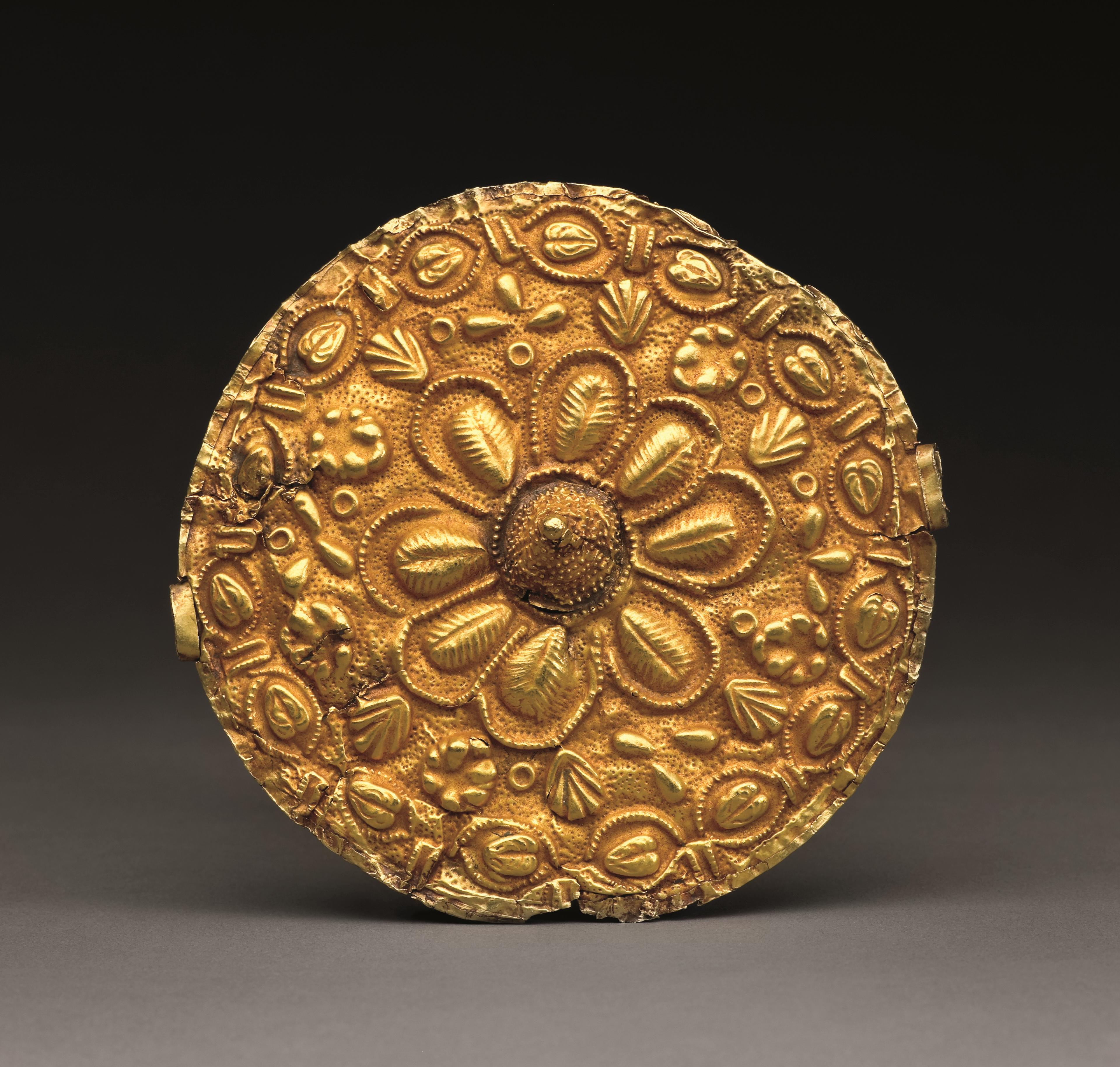Unknown Asante artist. Disk Pendant (Akrafokonmu), 20th century, Ghana. Gold, red ochre, 4 1/4 × 4 1/4 × 3/4 in. (10.8 × 10.8 × 1.9 cm). Lent courtesy of the Samuel P. Harn Museum of Art, University of Florida; Museum purchase with funds provided by the Caroline Julier and James G. Richardson Art Acquisition Fund, 2004.20.2. (Photo: Randy Batista)