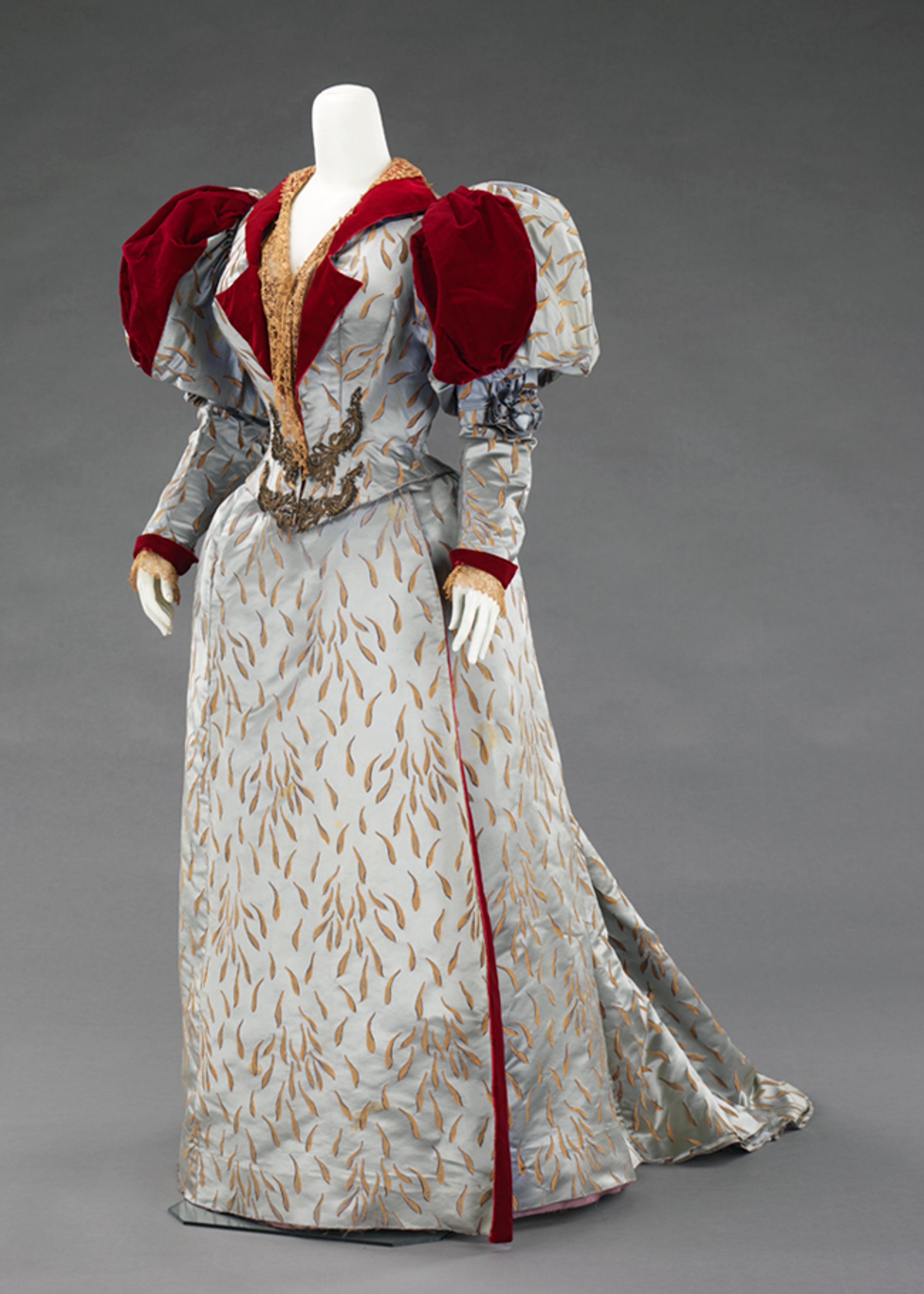 Charles Frederick Worth (French, born Britain, 1825–1895) or Jean-Philippe Worth (French, 1856–1926). Evening Dress, 1893. Blue silk satin patterned with gold chrysanthemum petals, red silk velvet, ecru machine-made lace, beadwork, and metallic passementerie. Brooklyn Museum Costume Collection at The Metropolitan Museum of Art, Gift of the Brooklyn Museum, 2009; Formerly Collection of Emma Frink Perry; Gift of Edith Gardiner, 1926 (2009.300.622a–c)