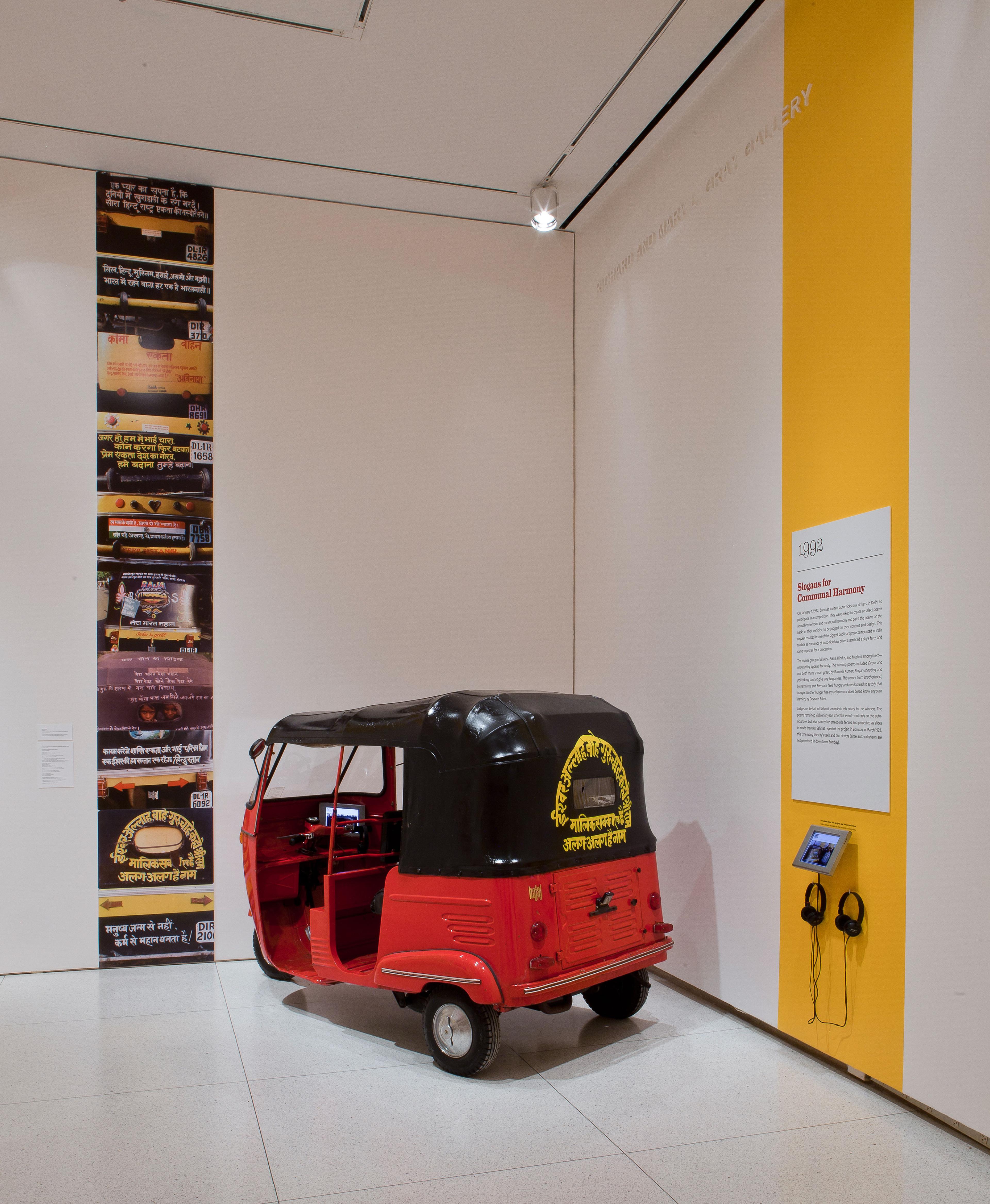 SAHMAT [Safdar Hashmi Memorial Trust] (founded 1989). Slogans for Communal Harmony (Auto-rickshaw project), 1992/2013. Rickshaw, steel with vinyl top; documentary photographs and video; rickshaw: 651/2 × 501/2 × 108 in. (166.4 × 128.3 × 274.3 cm), cover: 301/2 × 45 × 601/2 in. (77.5 × 114.3 × 153.7 cm). The David and Alfred Smart Museum of Art, The University of Chicago. (Photo: © 2015 courtesy of The David and Alfred Smart Museum of Art, The University of Chicago)