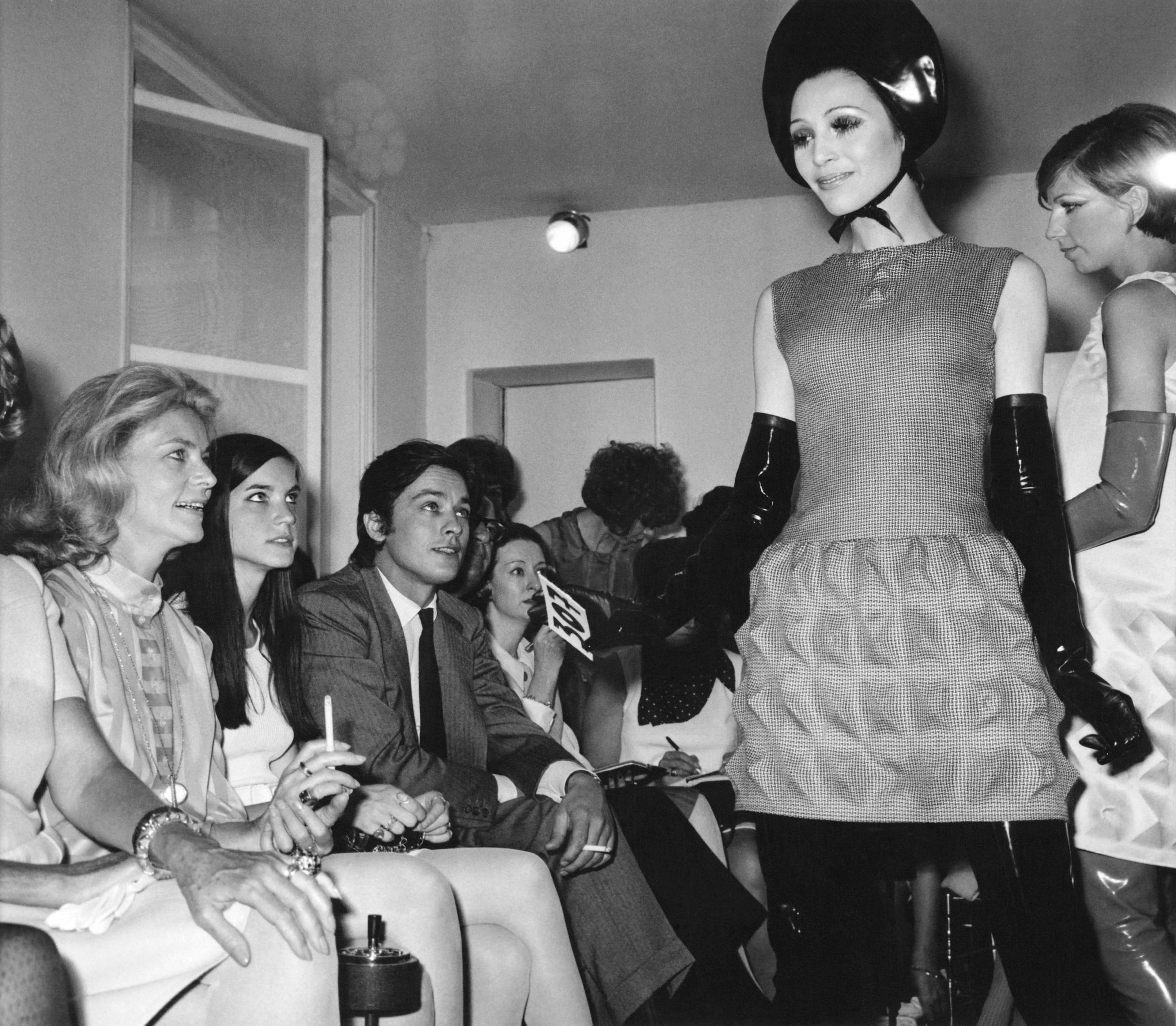 Lauren Bacall, Leslie Bogart, and Alain Delon at Pierre Cardin's Fall 1968 fashion show. (Photo: Courtesy of Archives Pierre Cardin. © Archives Pierre Cardin)