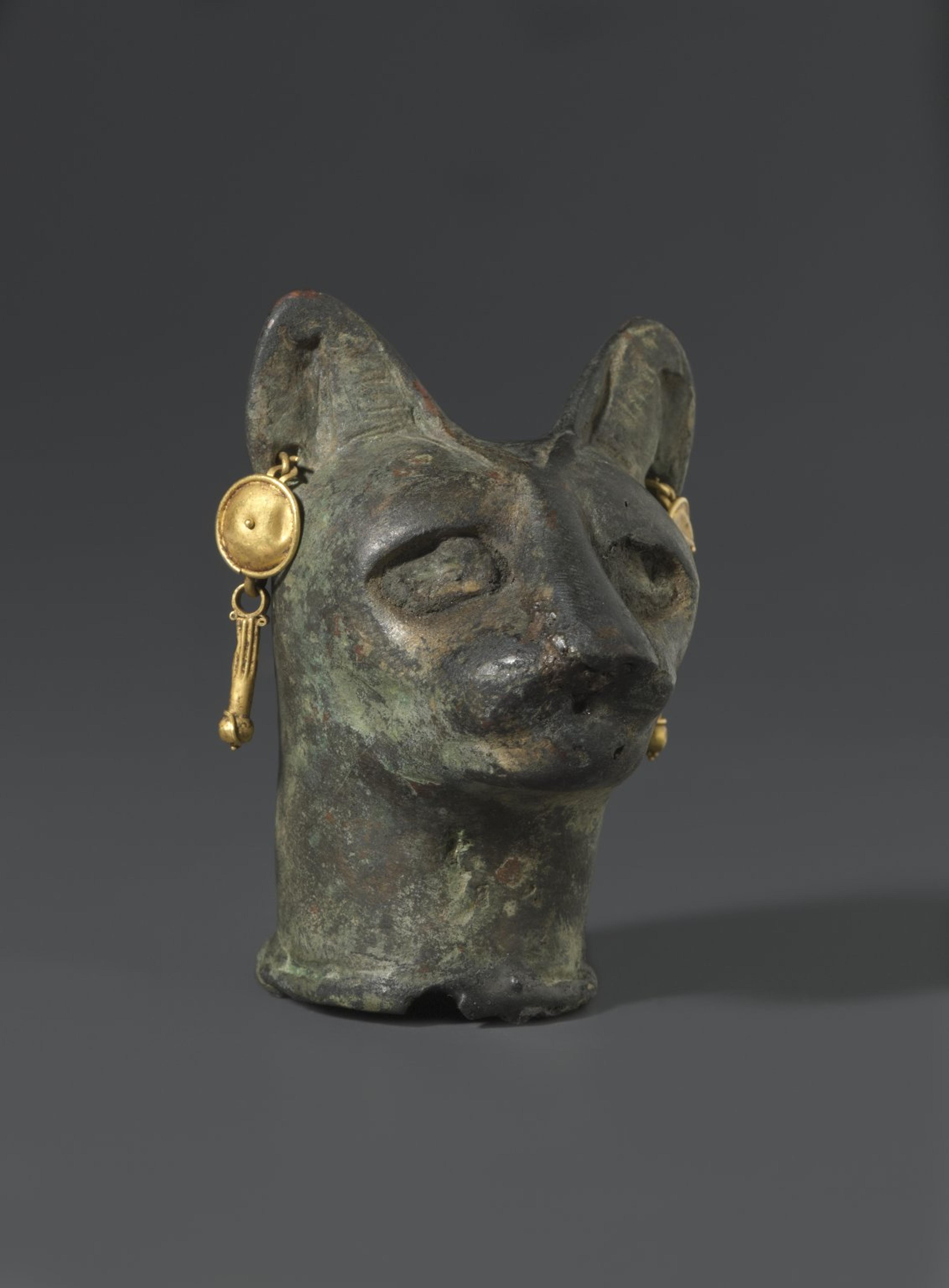 Cat’s Head. From Egypt. Roman Period, 30 B.C.E.–third century C.E. Bronze, gold, 23⁄8 x 13⁄4 x 113⁄16 in. (6 × 4.4 × 4.6 cm). Brooklyn Museum, Charles Edwin Wilbour Fund, 36.114