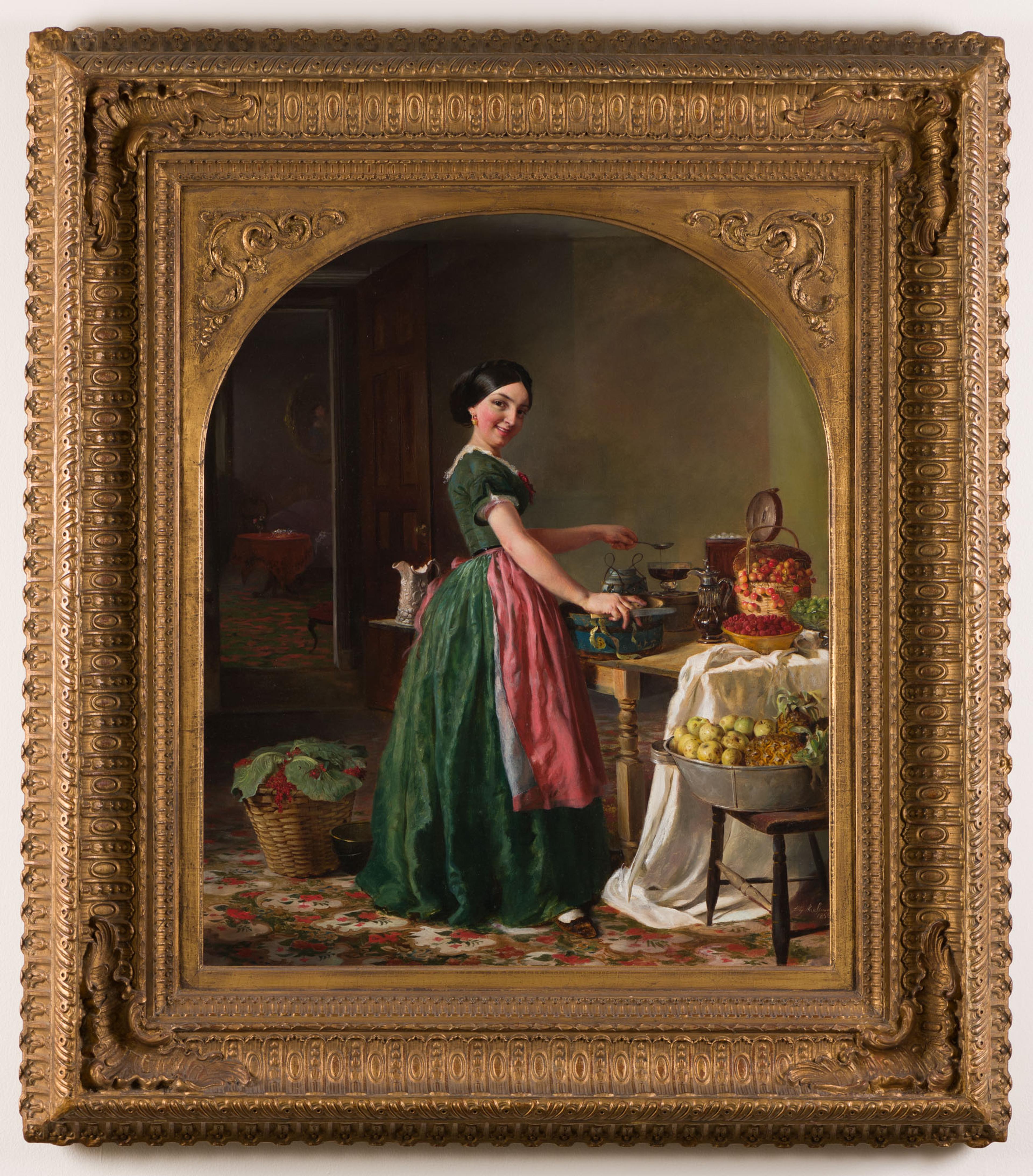 A framed painting of a women in a green dress and pink apron, cooking at a table and smiling at the viewer