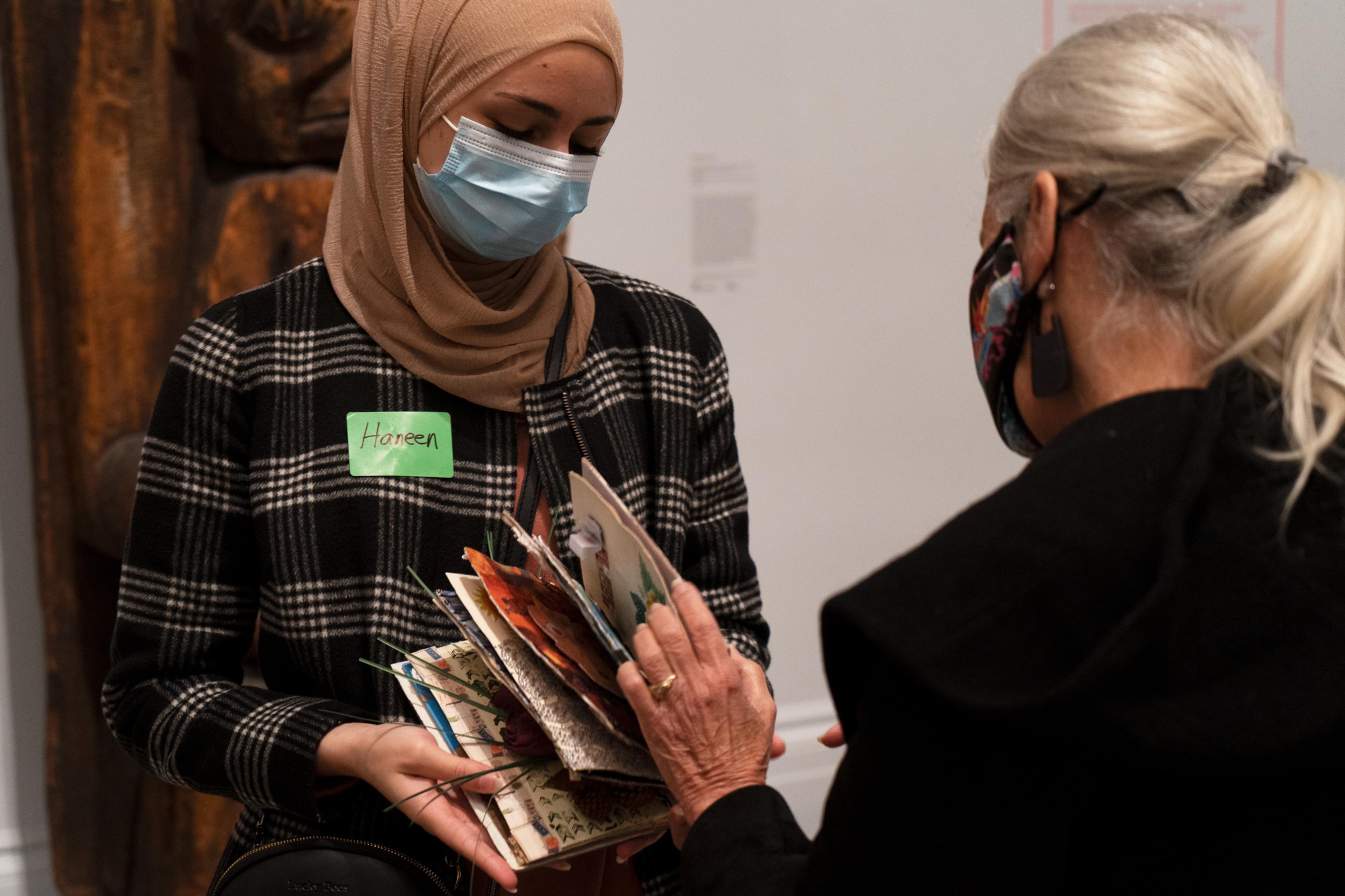 A participant presents their altered book project, 2021. (Photo: Faviola Lopez-Romani)