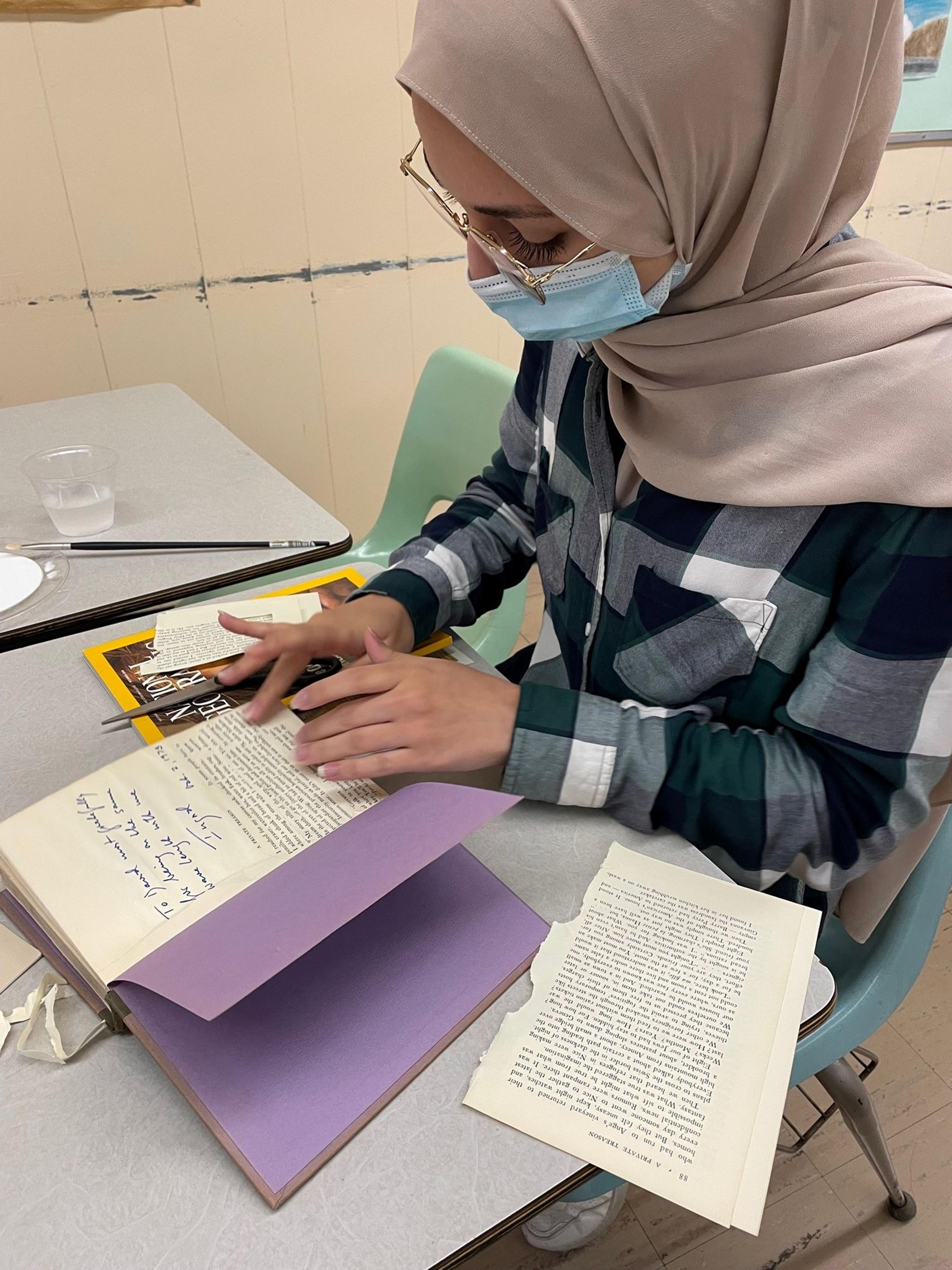 A student works on an altered book, 2021. (Photo: Caryn Davis)