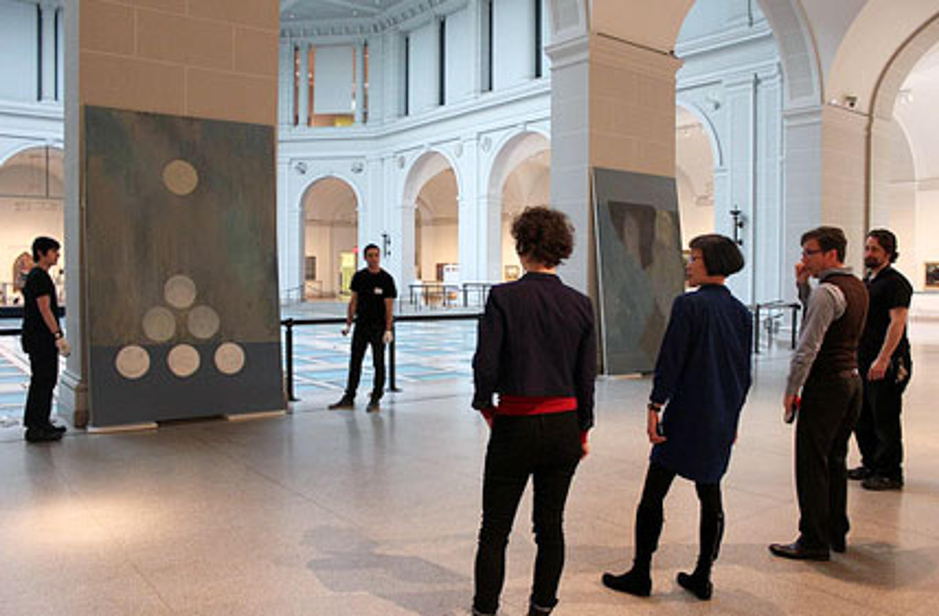 Shura Chernozatonskaya and curator Eugenie Tsai work with Museum staff to install Russian Modern, one of a pair of paintings that responds to the “Russian Modern” section of the installation European Paintings, in the Beaux-Arts Court
