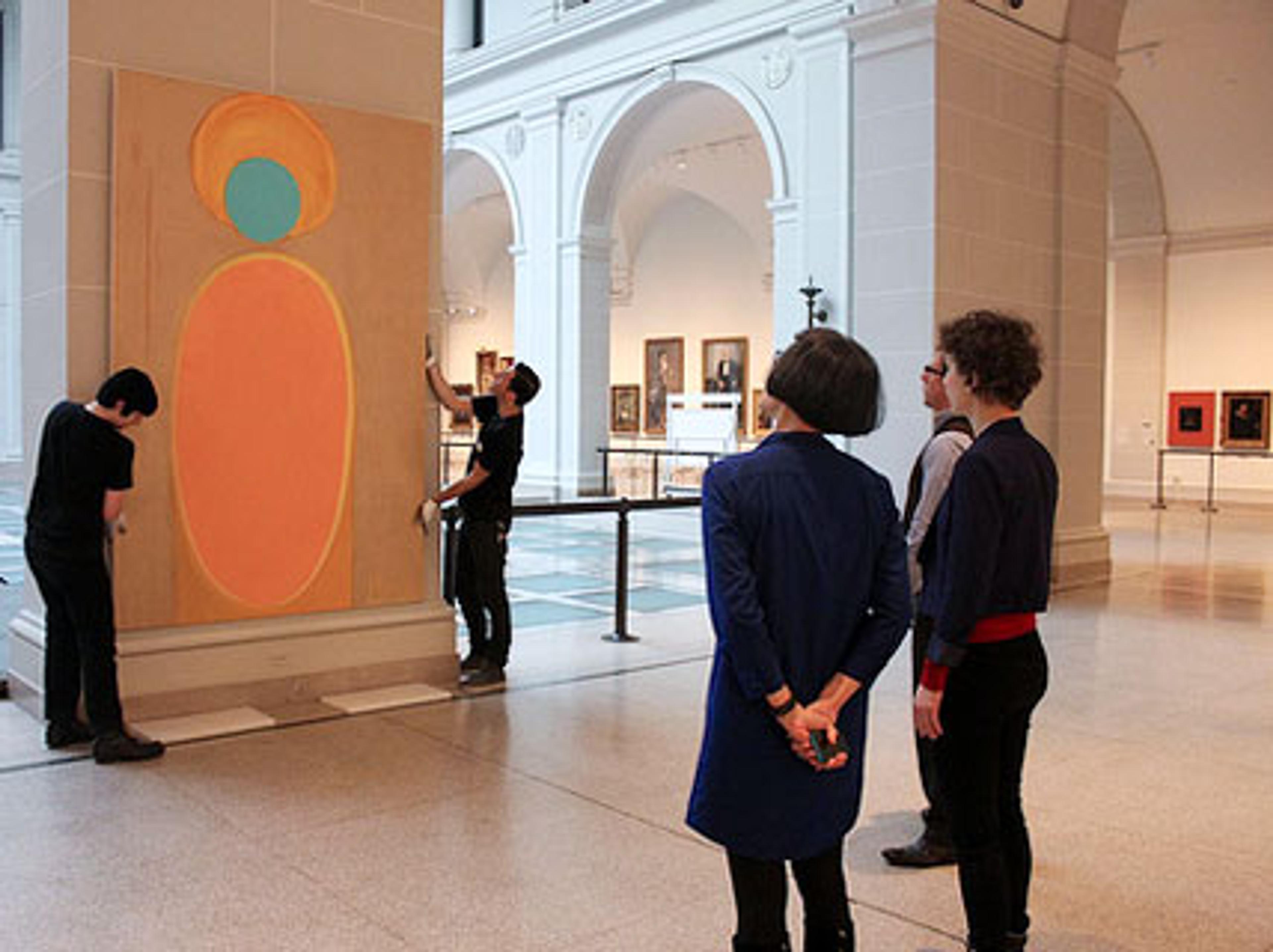 Shura Chernozatonskaya and curator Eugenie Tsai work with Museum staff to install Art, one of a pair of paintings that responds to the “Art and Devotion” section of the installation European Paintings, in the Beaux-Arts Court