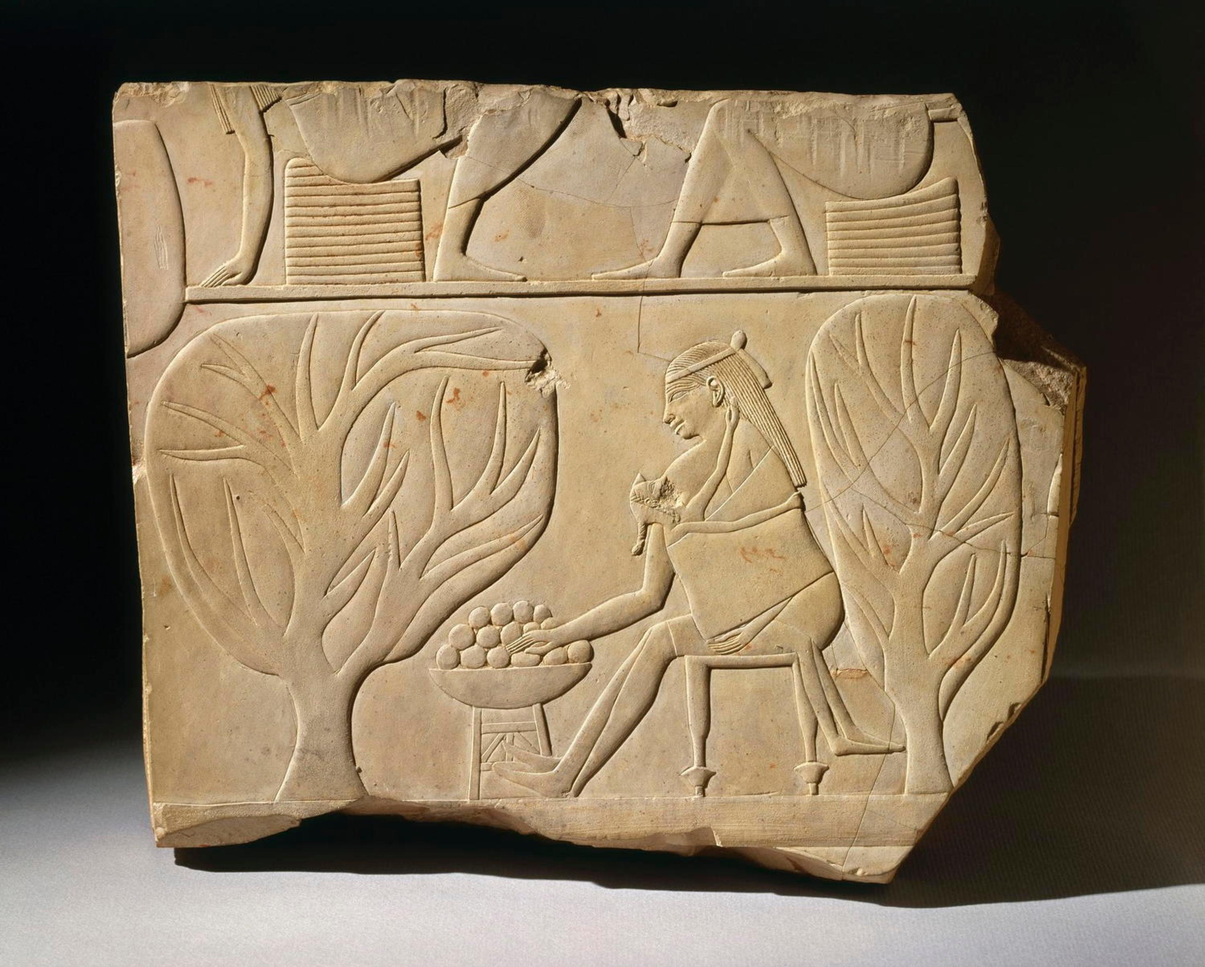 Egyptian. <i>Woman with a Baby Stacking Fruit</i>, ca. 670–650 B.C.E.. Limestone, 9 7/16 x 11 5/16 in. (23.9 x 28.7 cm). Brooklyn Museum, Charles Edwin Wilbour Fund, 48.74. (Photo: Brooklyn Museum)