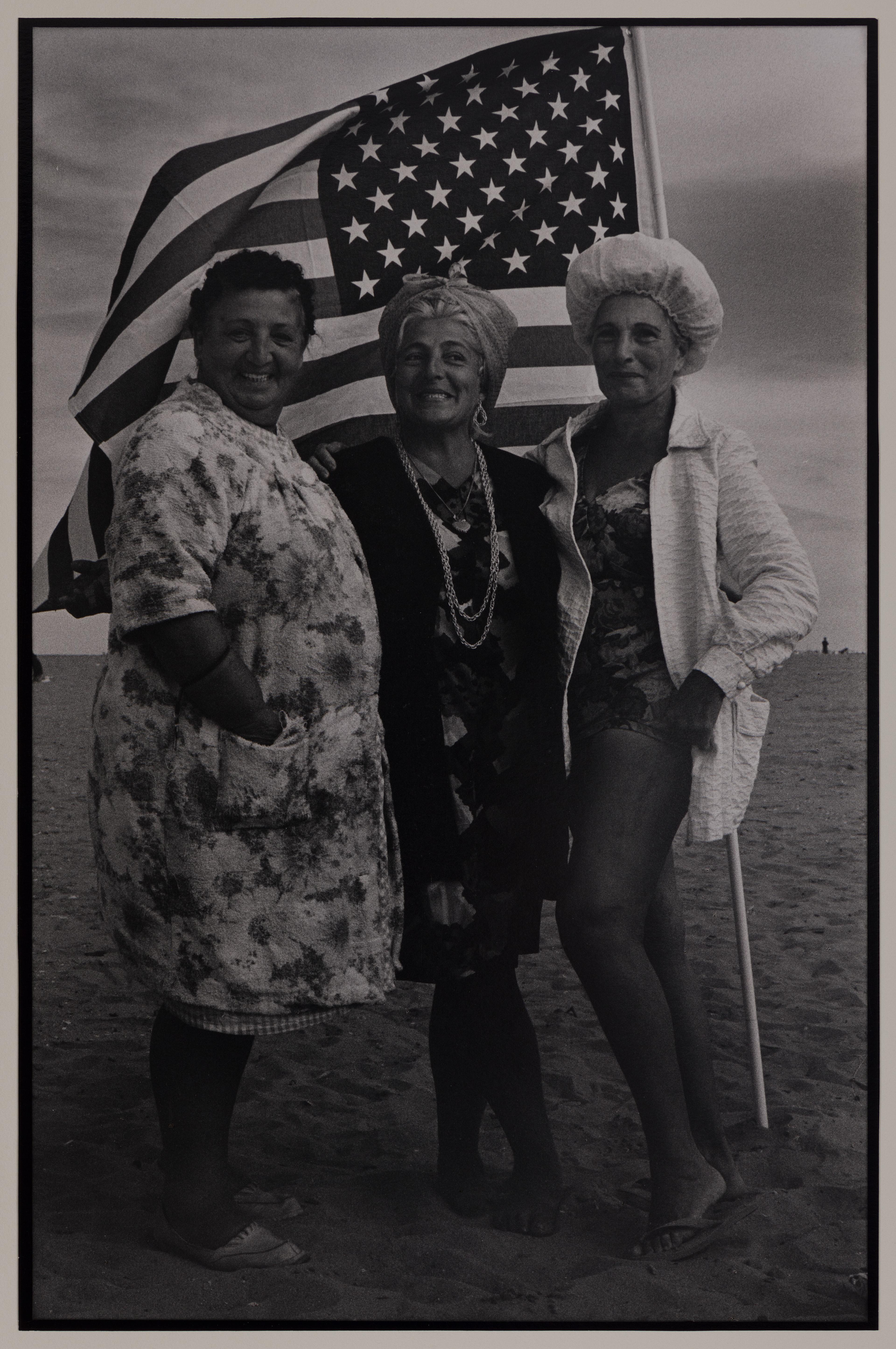 Victor Friedman. <i>Three Women and Flag, Coney Island</i>, 1972. Gelatin silver print. Brooklyn Museum; Gift of the artist, 83.76.6. © Victor Friedman. (Photo: Brooklyn Museum)