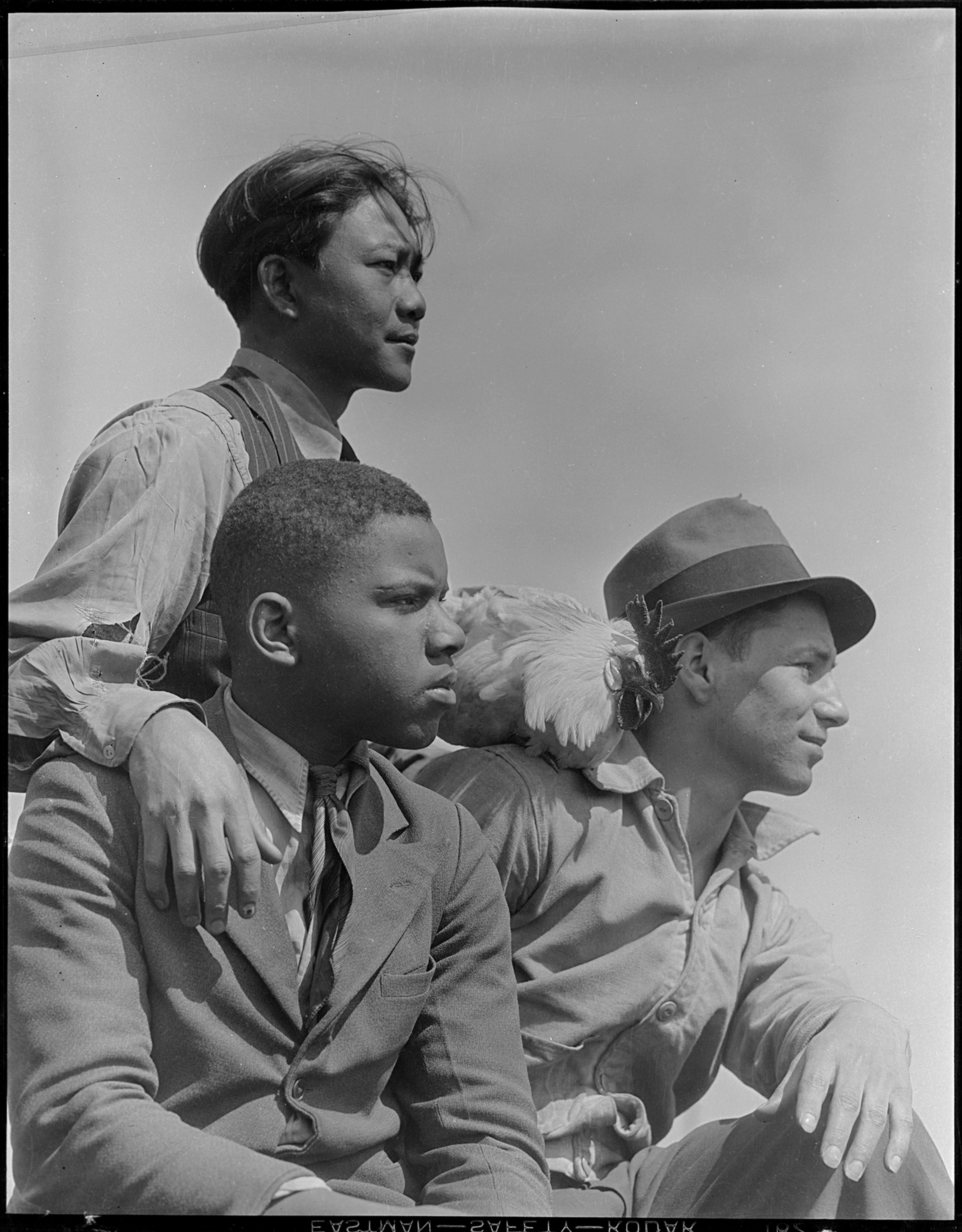 Black-and-white photograph of three men in profile
