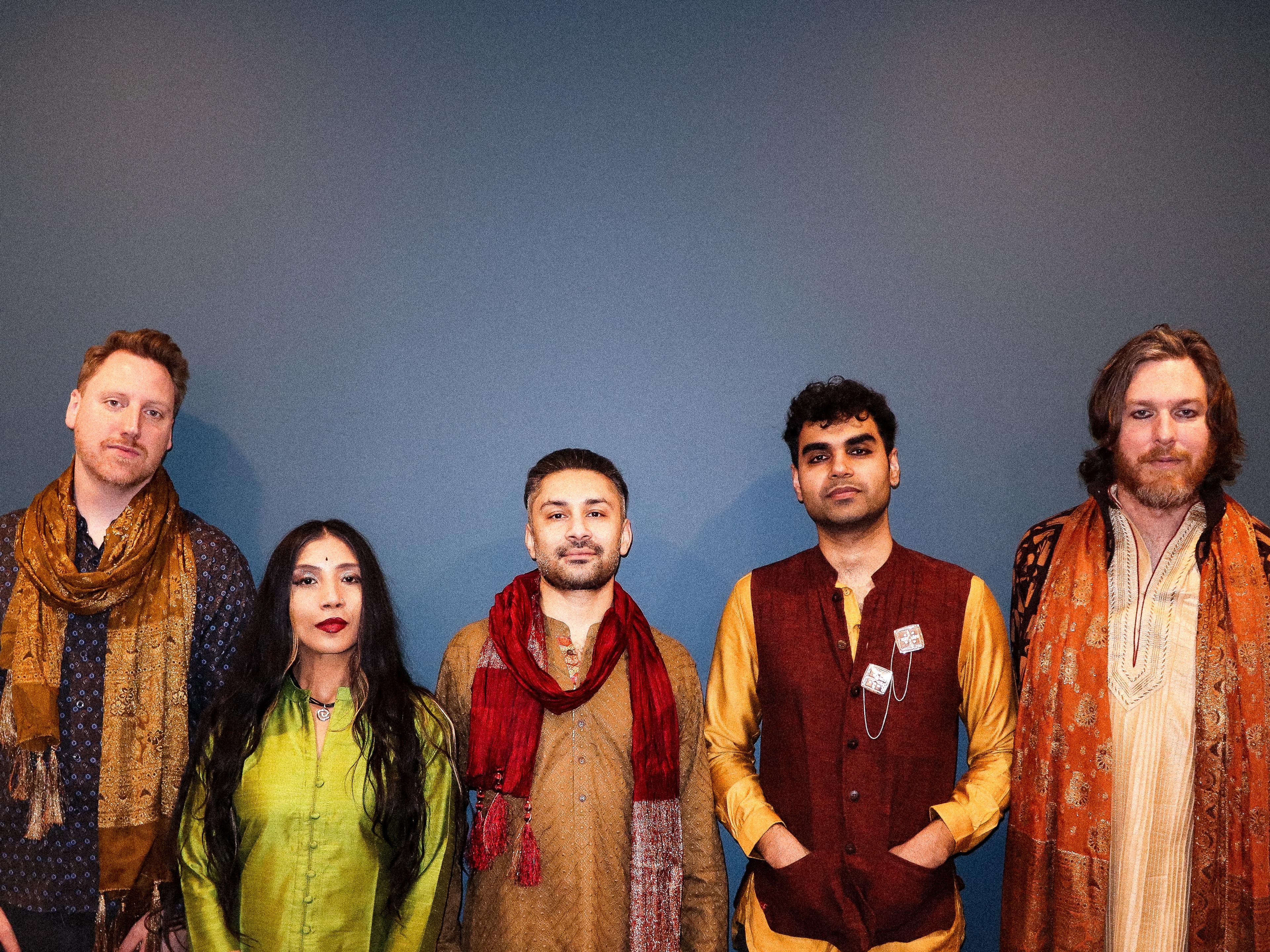 Five people wearing colorful garments and accessories