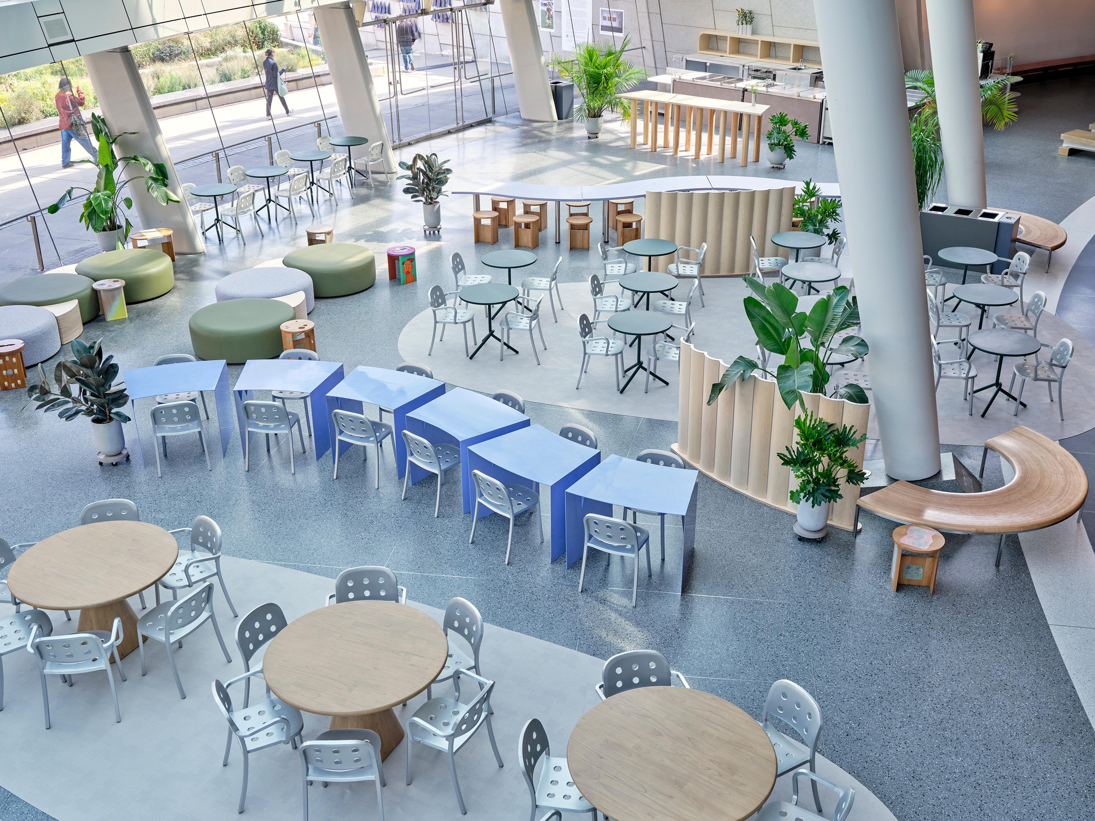 View of a sunlit lobby with tables and chairs