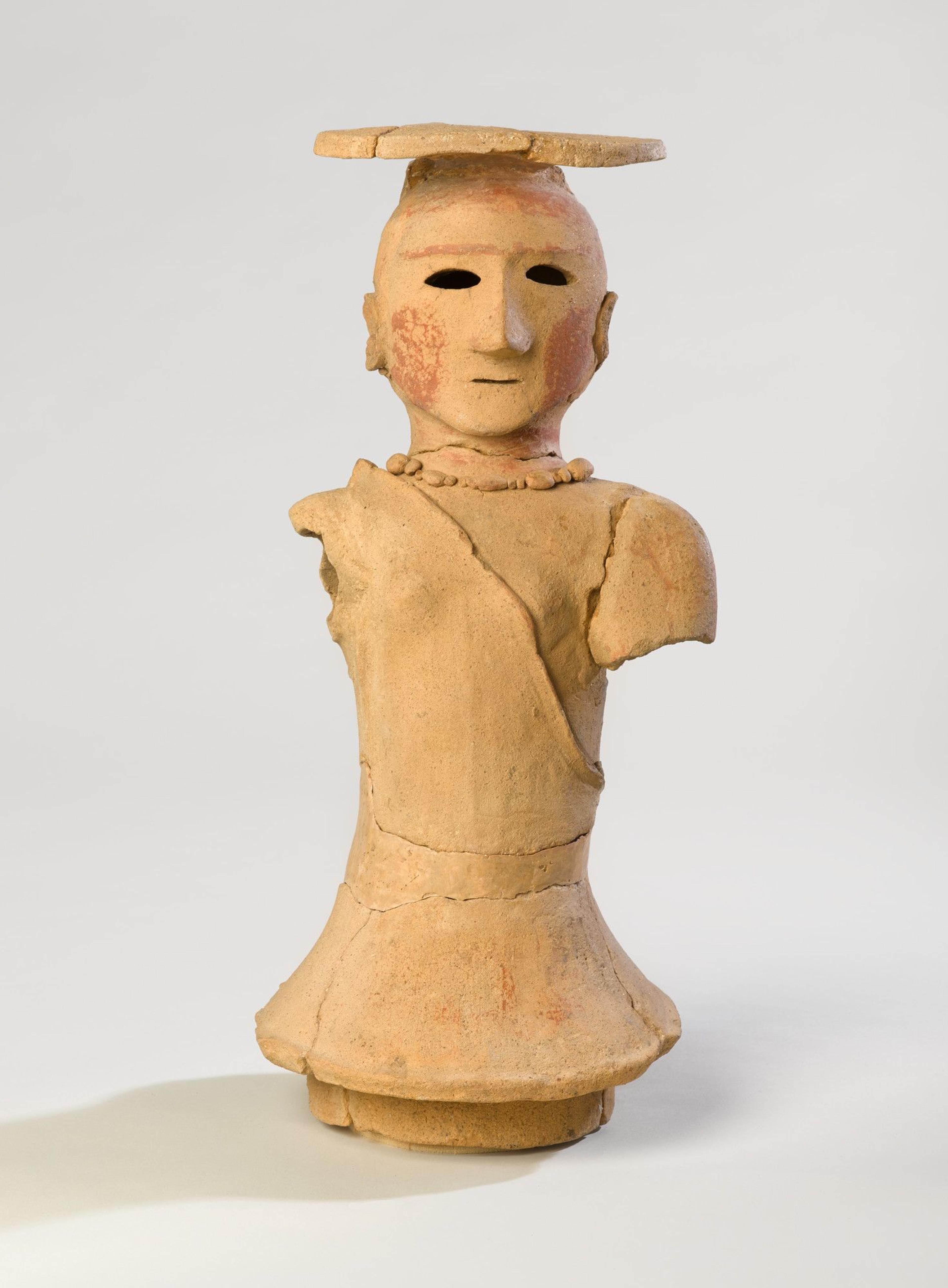 Haniwa Figure of a Woman. Japan, Kofun period, 5th–6th century. Earthenware with traces of pigment, 18 × 8 3/4 × 7 1/2 in. (45.7 × 22.2 × 19.1 cm). Brooklyn Museum; Gift of Mr. and Mrs. Stanley Marcus, 79.278.1. (Photo: Brooklyn Museum)