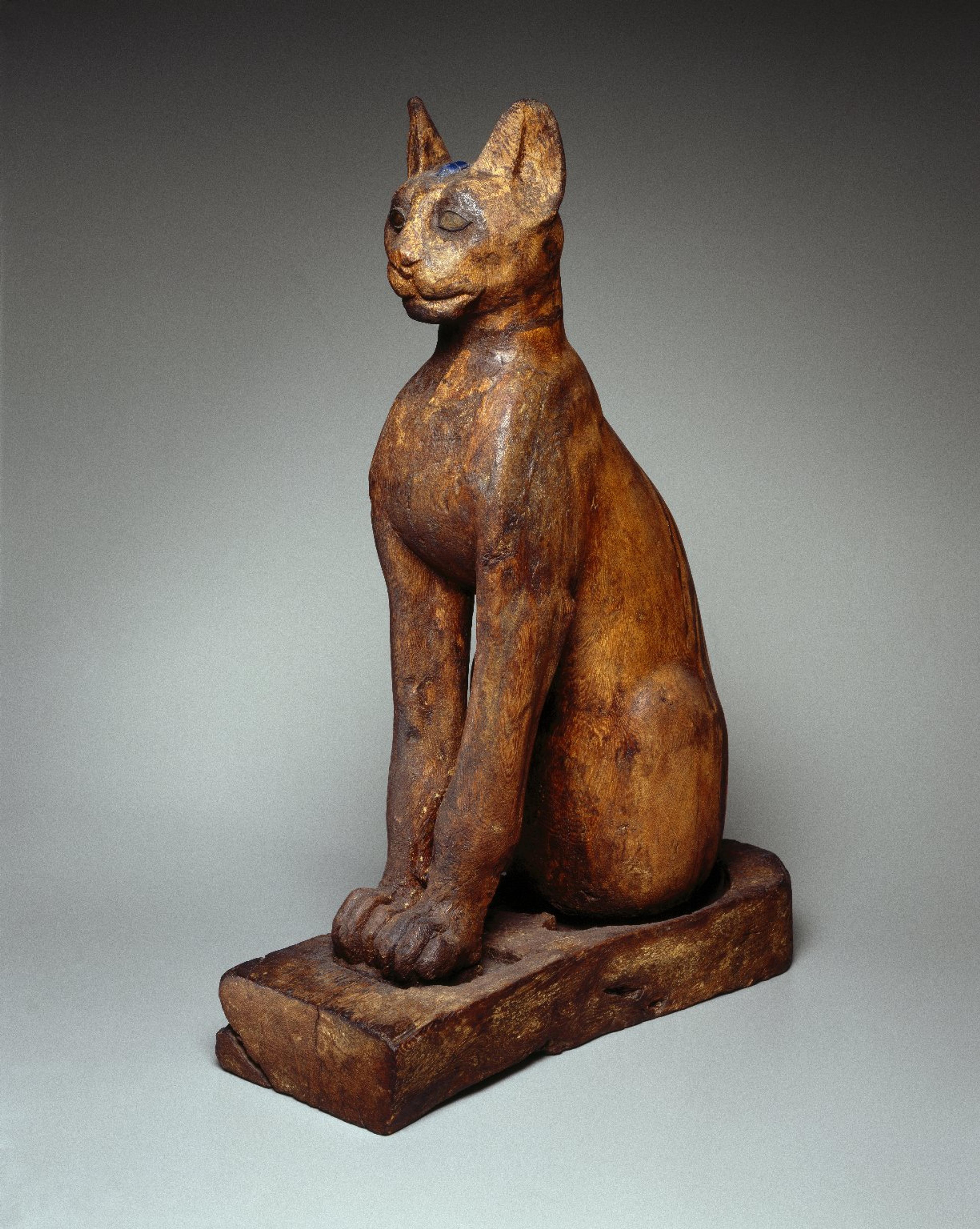 Figure of a Cat. From Egypt. Ptolemaic Period–Roman Period, 305 B.C.E.–first century C.E. Wood, gilded gesso, bronze, rock crystal, glass, 259⁄16 x 65⁄16 x 1113⁄16 in. (65 × 16 × 30 cm). Brooklyn Museum, Charles Edwin Wilbour Fund, 37.1945E