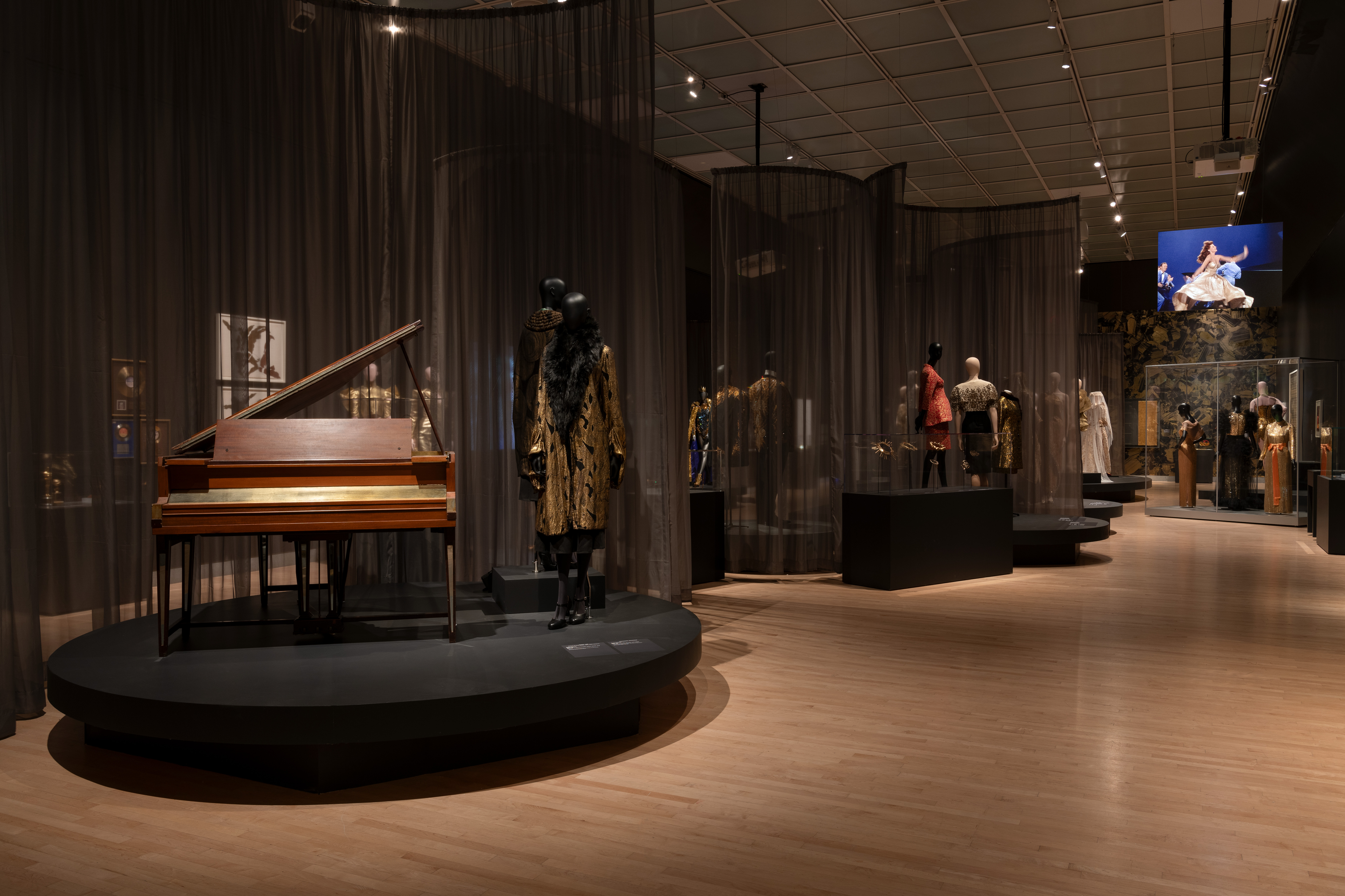 A view of fashions and a piano in Solid Gold