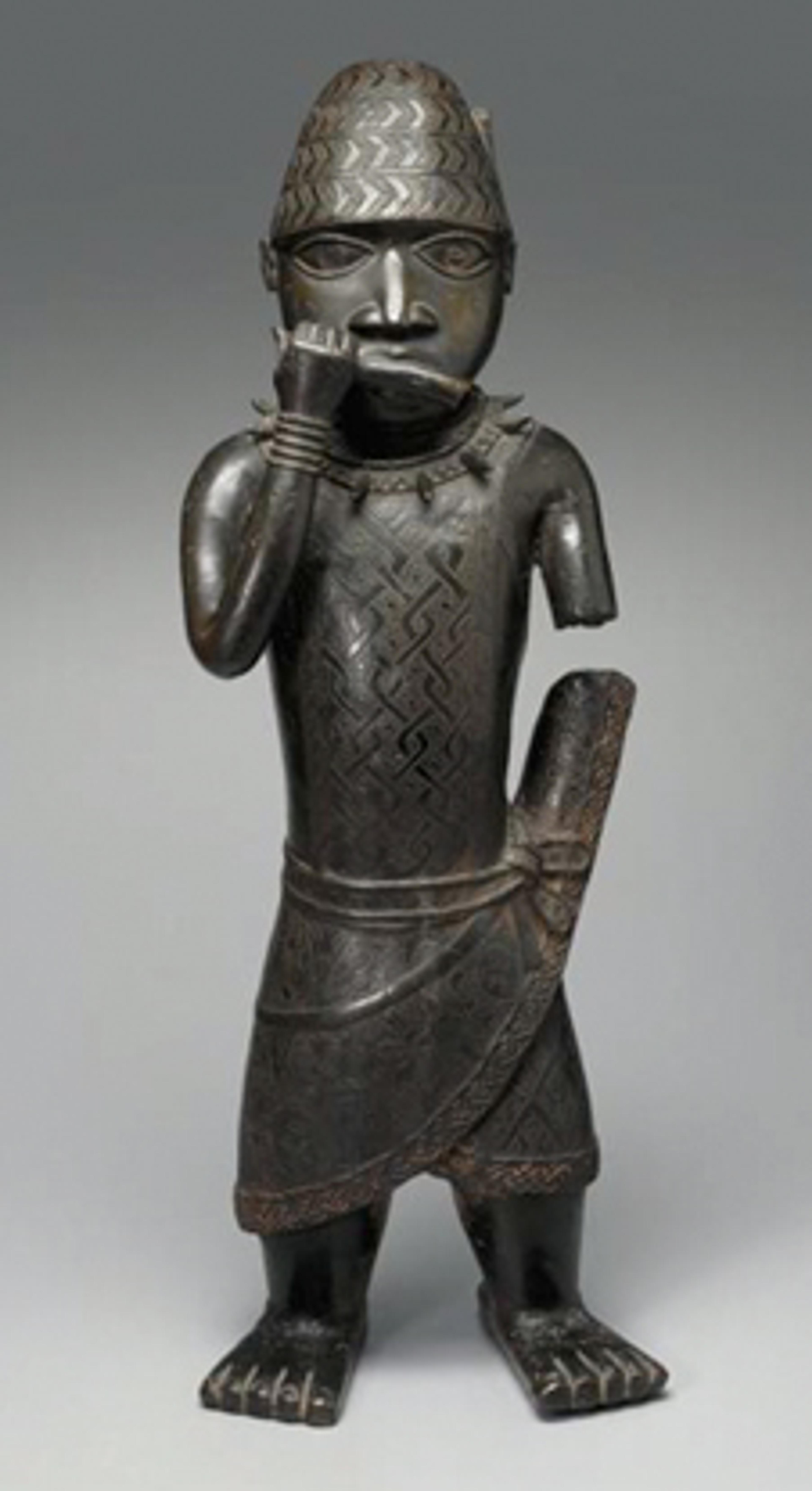 Figure of a Horn Blower. Unidentified Edo artist, circa 1504–50. Benin, Edo state, Nigeria. Copper alloy, 241⁄2 x 81⁄2 x 6 in. (62.2 × 21.6 × 15.2 cm). Gift of Mr. and Mrs. Alastair B. Martin, the Guennol Collection, 55.87