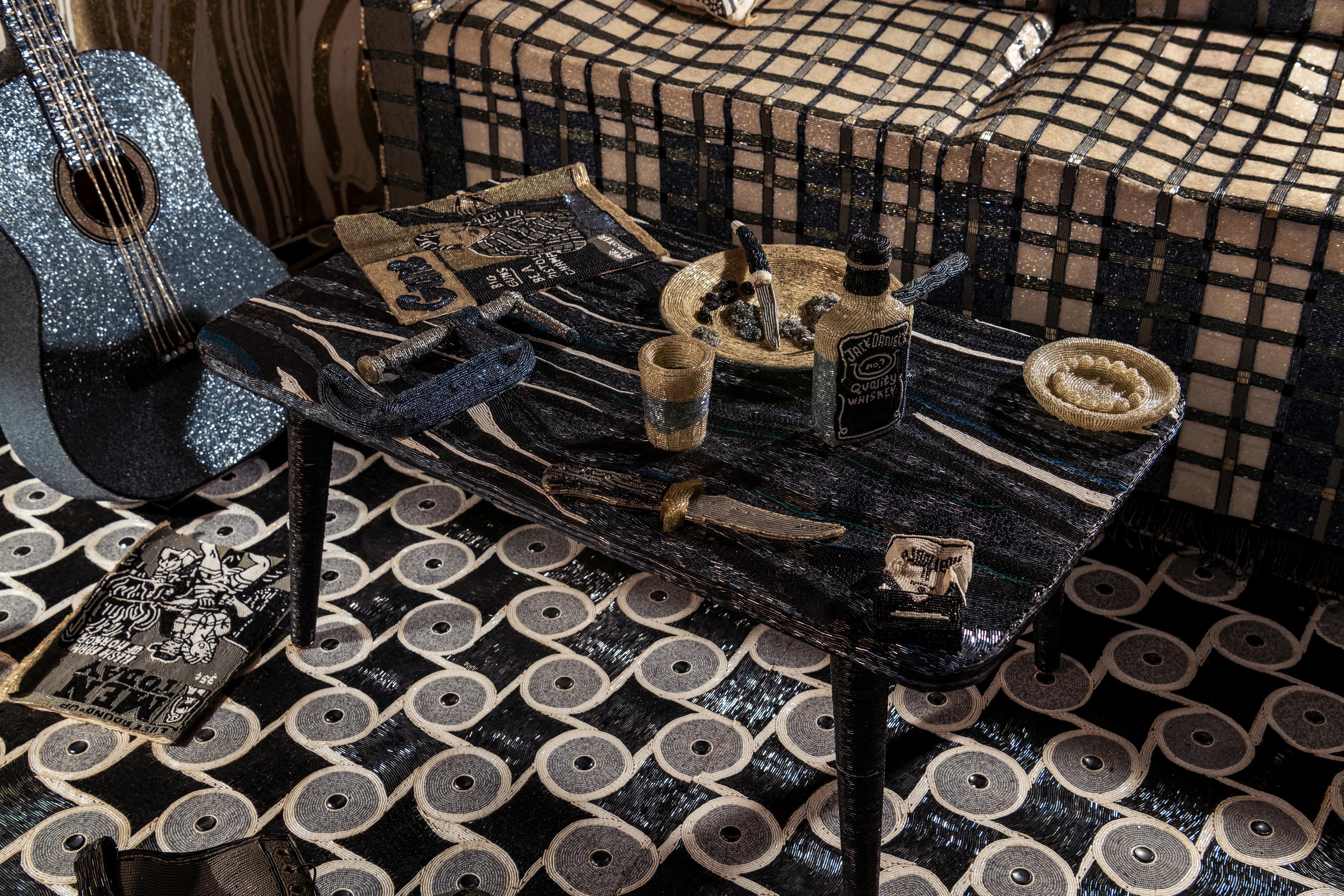 Detail of a scene showing a coffee table and guitar