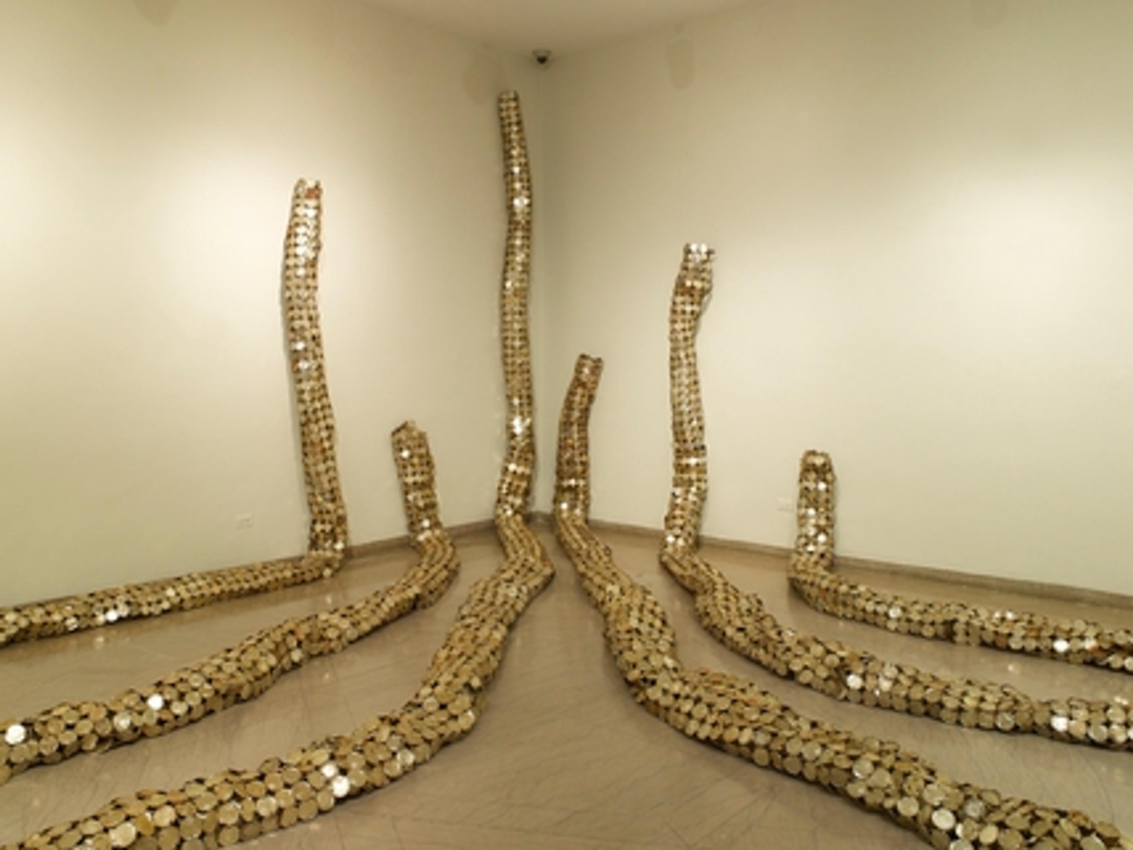 El Anatsui (Ghanaian, b. 1944). Drainpipe, 2010. Tin and copper wire, installation at the Brooklyn Museum, dimensions variable. Courtesy of the artist and Jack Shainman Gallery, New York. Brooklyn Museum photograph