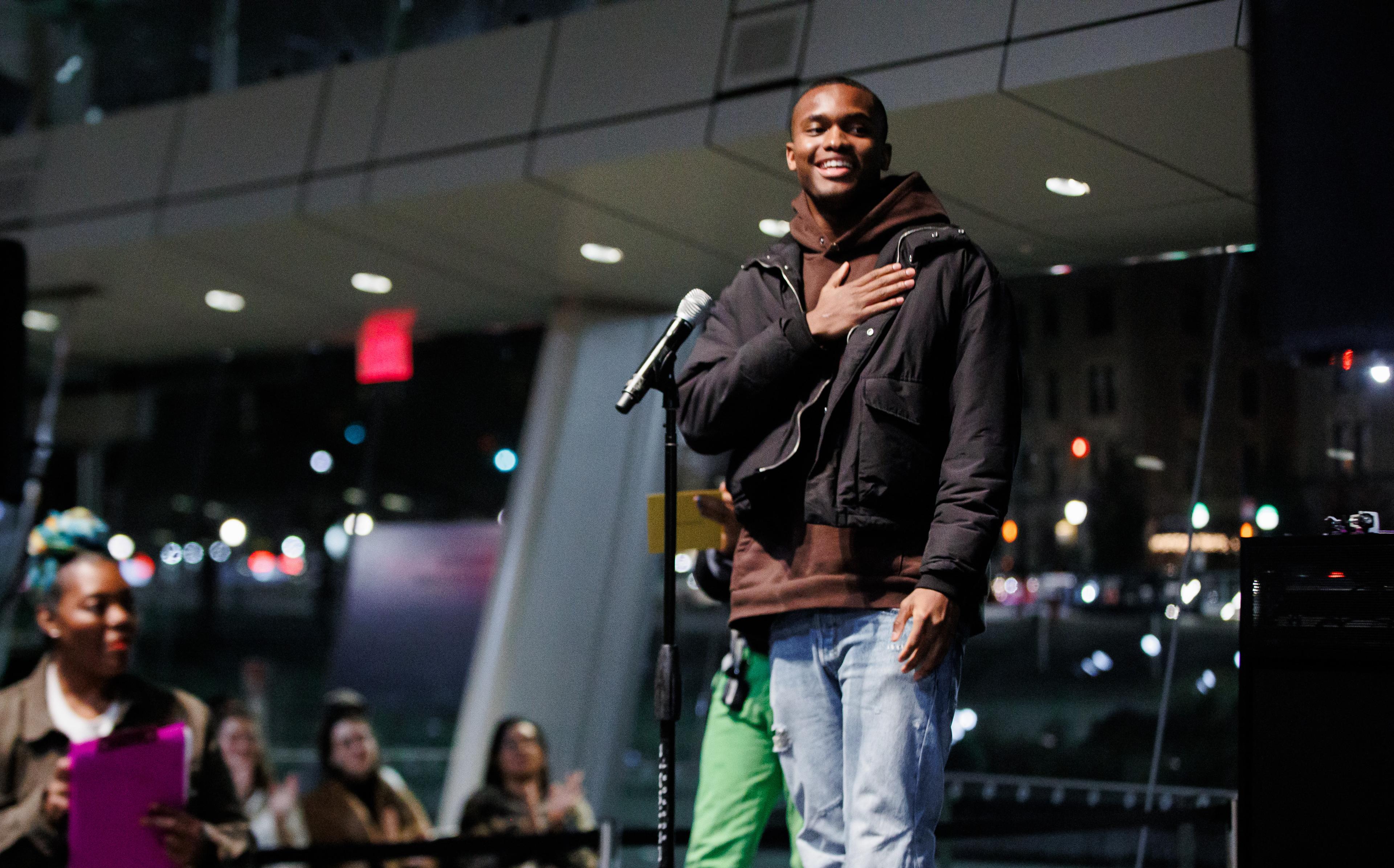 A person standing in front of a microphone