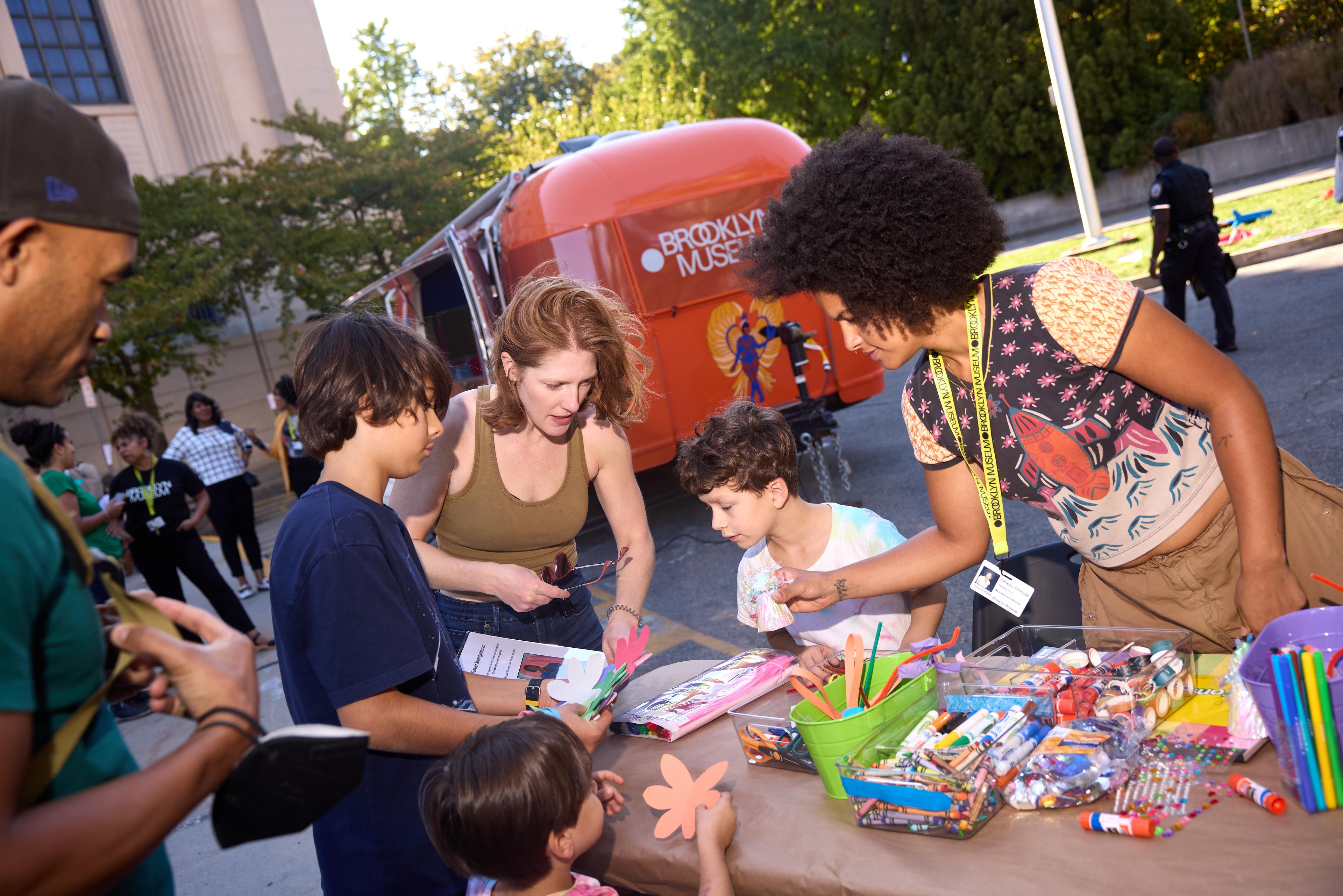 Children and adults participating in an art-making activity