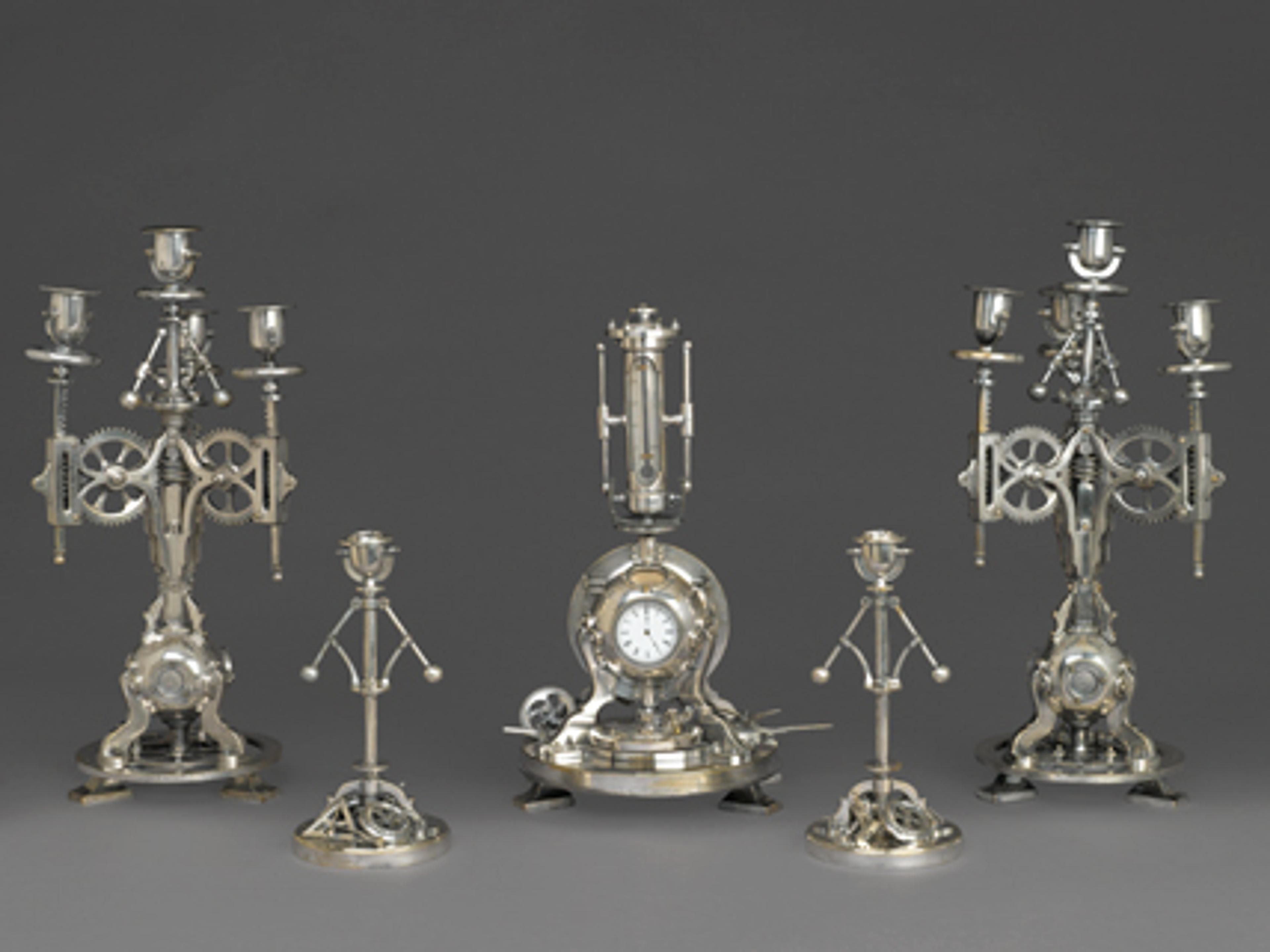 Guilmet Cie (active 1861–1910). Five-Piece Clock Garniture, circa 1885. Silvered bronze, 91⁄4 x 41⁄2 x 41⁄2 in. (23.5 × 11.4 × 11.4 cm). Brooklyn Museum; Gift of Marcus S. Friedlander, by exchange, 2009.49.1-5