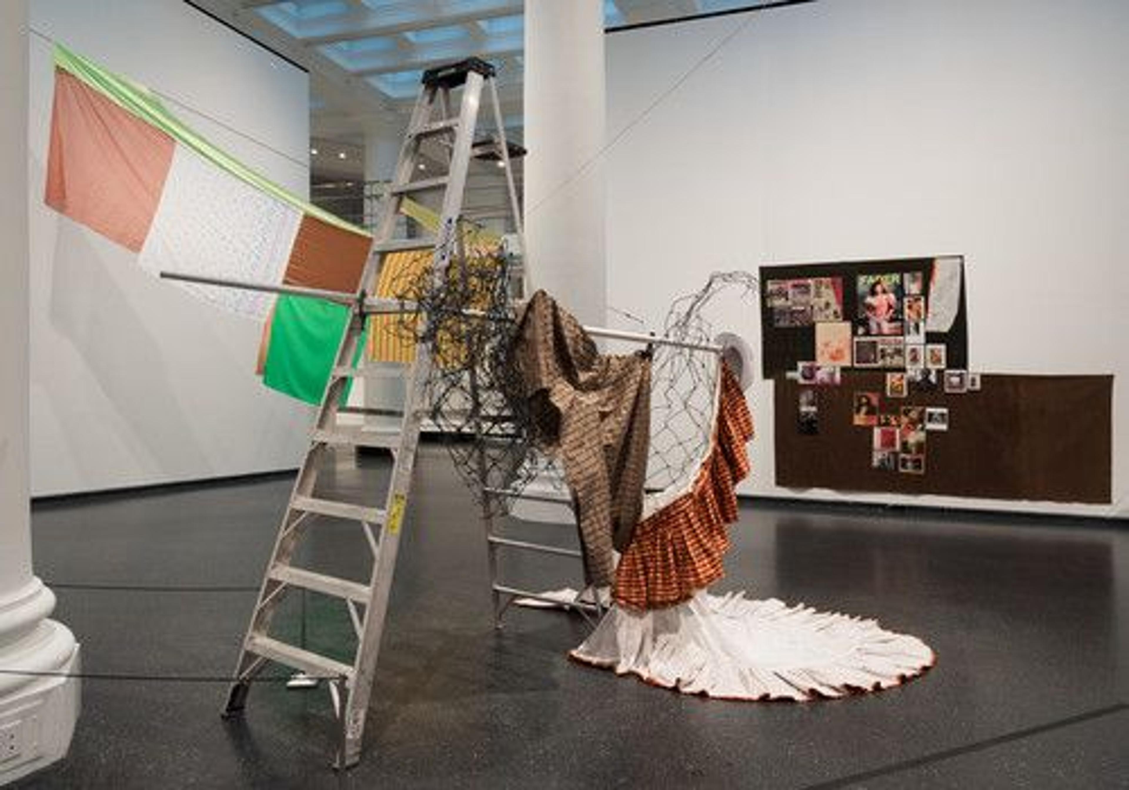 Installation view, Eric N. Mack: Lemme walk across the room (visible: The opposite of the pedestal is the grave, 2017; Tessuti Raponi (Ciao Milano), 2018; Tartan Film Strip from 1987 till Recent, 2019). Brooklyn Museum, January 11–July 7, 2019. (Photo: Jonathan Dorado)