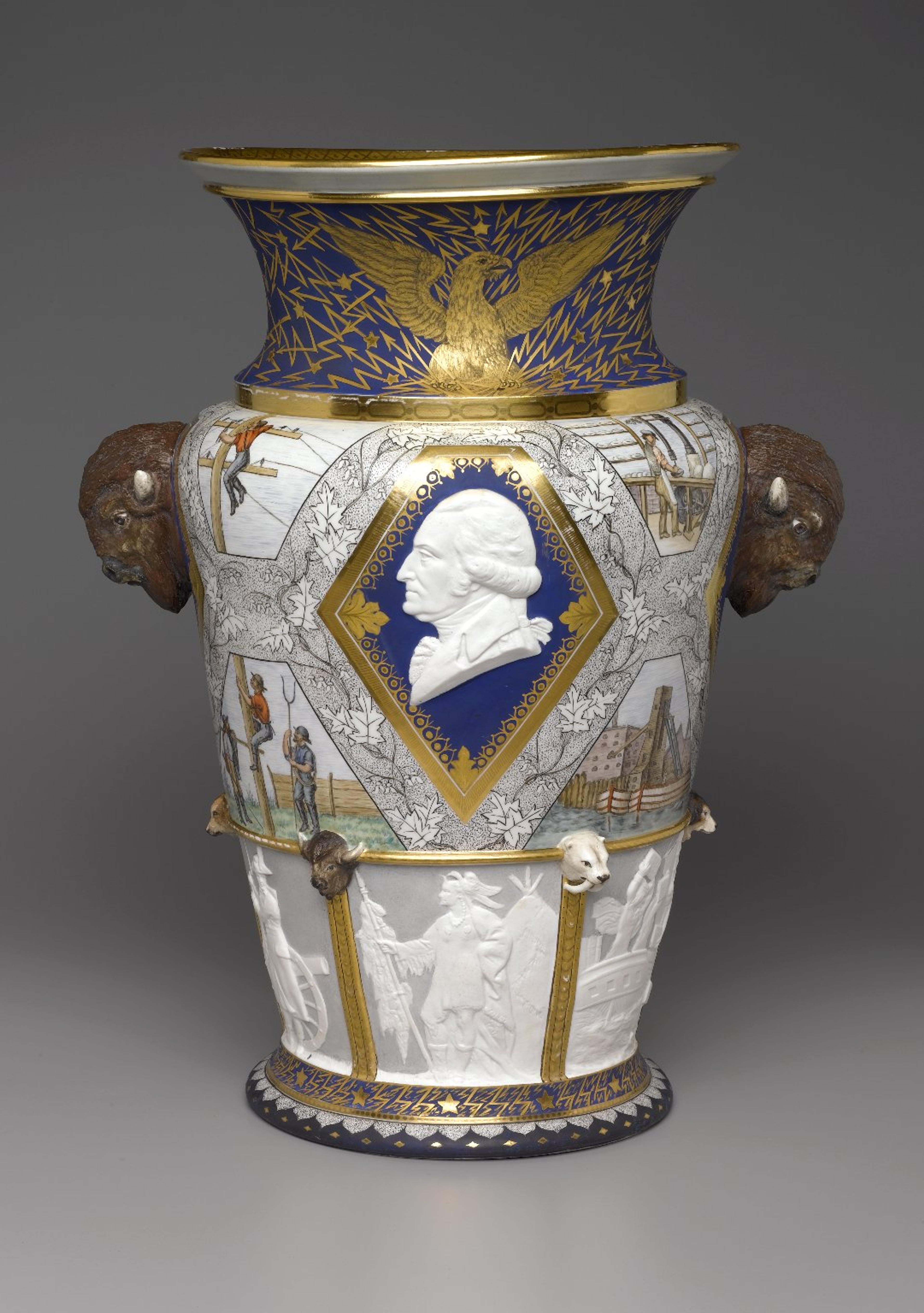 Large, elaborately decorated ceramic vase featuring the face of George Washington, heads of bison, and scenes of American history