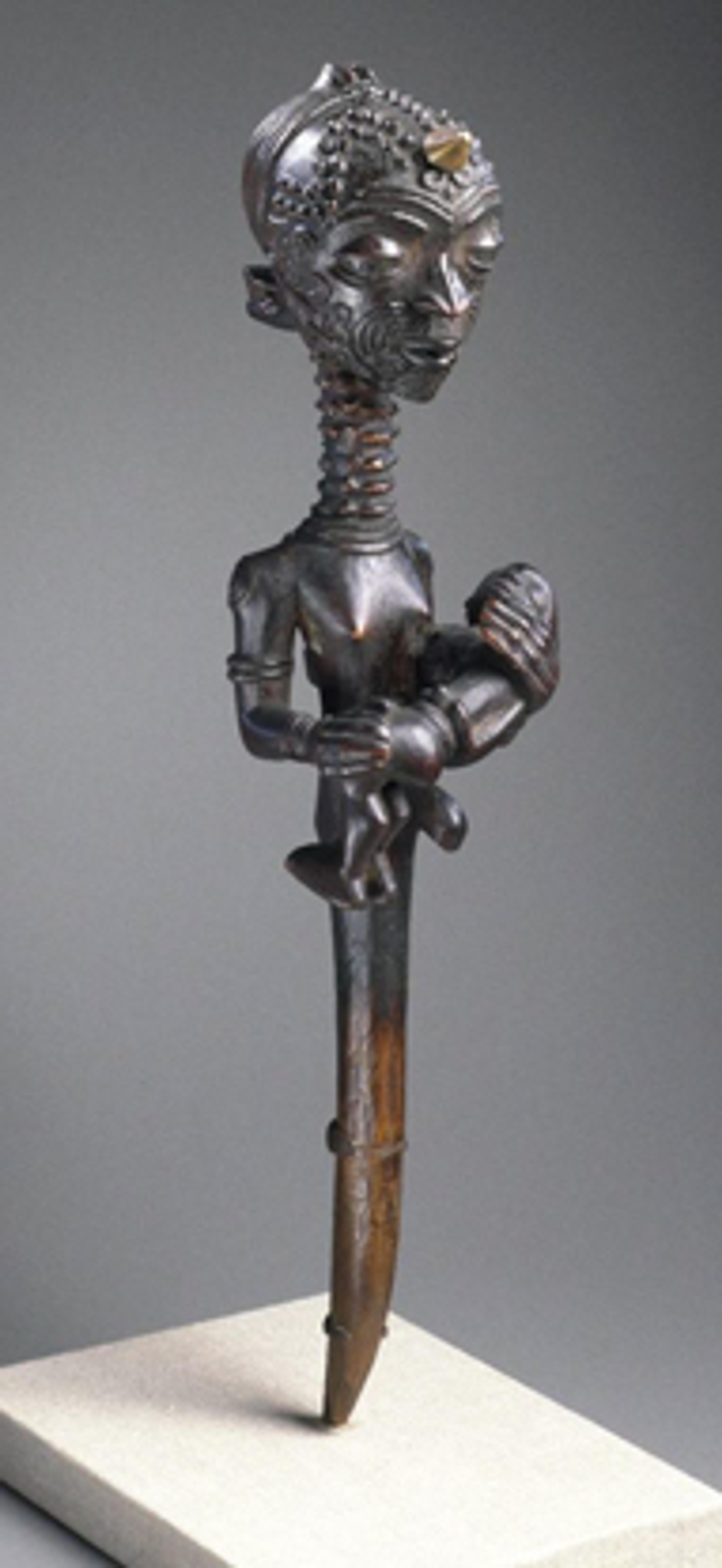 Mother with Child (Lupingu Iwa Cibola). Unidentified Lulua artist, 19th century. West Kasai province, Democratic Republic of the Congo. Wood, copper alloy, palm oil, camwood paste, organic materials, 14 × 33⁄8 x 31⁄2 in. (35.6 × 8.6 × 8.9 cm). Museum Collection Fund, 50.124