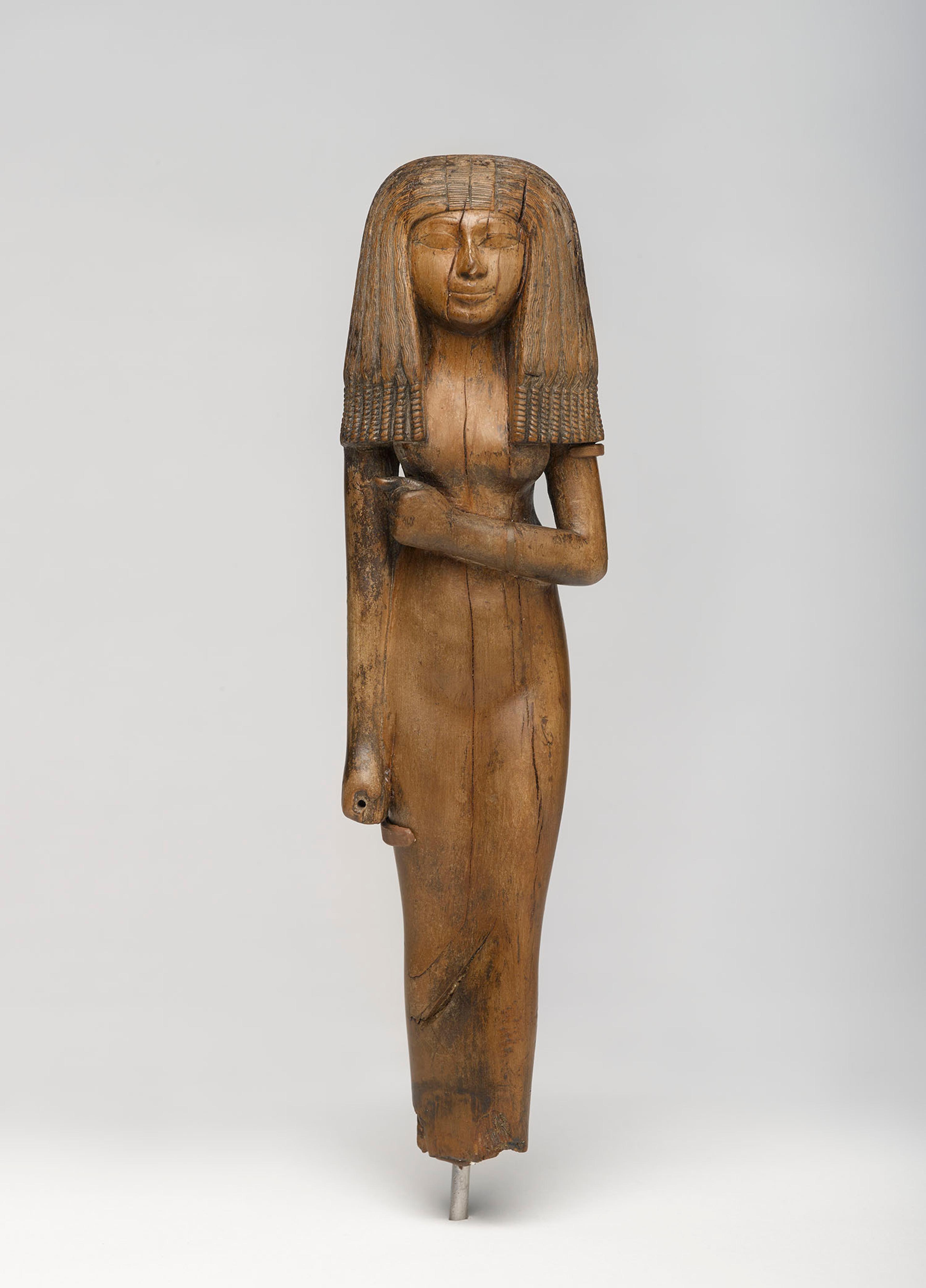 Statuette of a Woman, circa 1390–1353 B.C.E. Wood, 101/8 x 23/4 x 17/8 in. (25.6 x 7 x 4.8 cm). Charles Edwin Wilbour Fund, 54.29. (Photo: Jonathan Dorado, Brooklyn Museum)