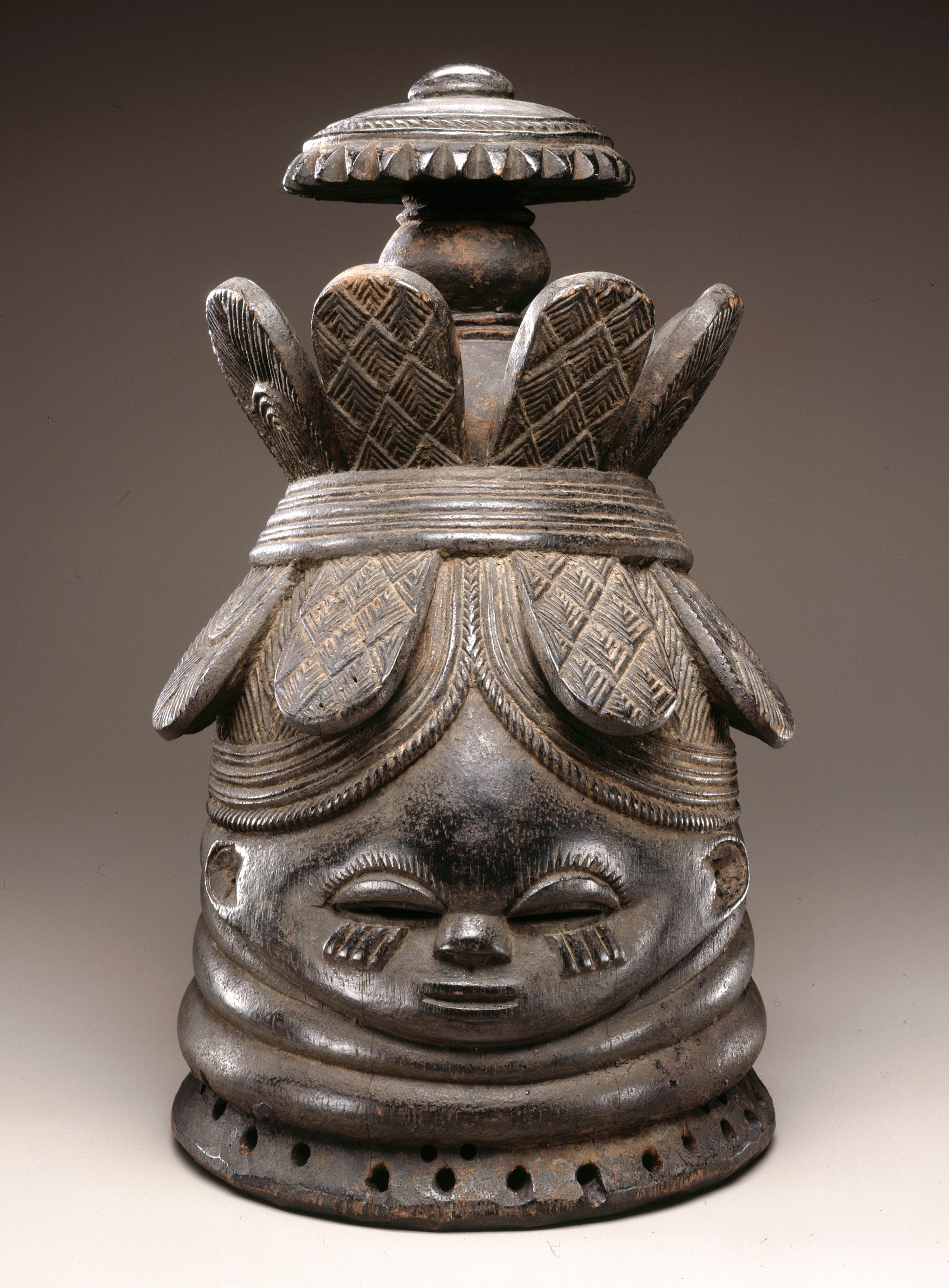 The Nguabu Master (Mende). Helmet Mask for Sande Society (Ndoli Jowei), late 19th-early 20th century. Nguabu, Moyamba district, Southern province, Sierra Leone. Wood, pigment, 151⁄2 x 91⁄4 x 101⁄4 in. (39.4 x 23.5 x 26 cm). Brooklyn Museum, Carll H. de Silver Fund, 74.64. Creative Commons-BY. Photo: Brooklyn Museum