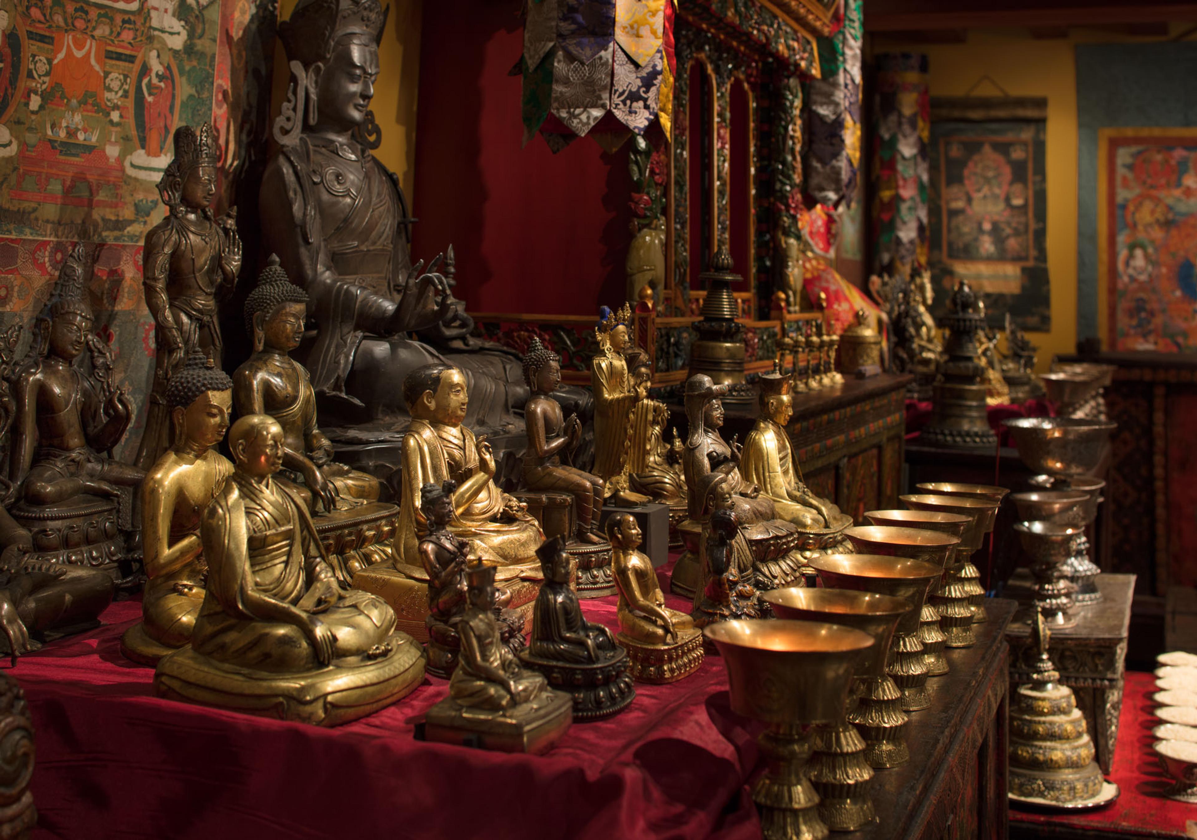 Bronze and gold sculptures arranged in a Tibetan Buddhist shrine room