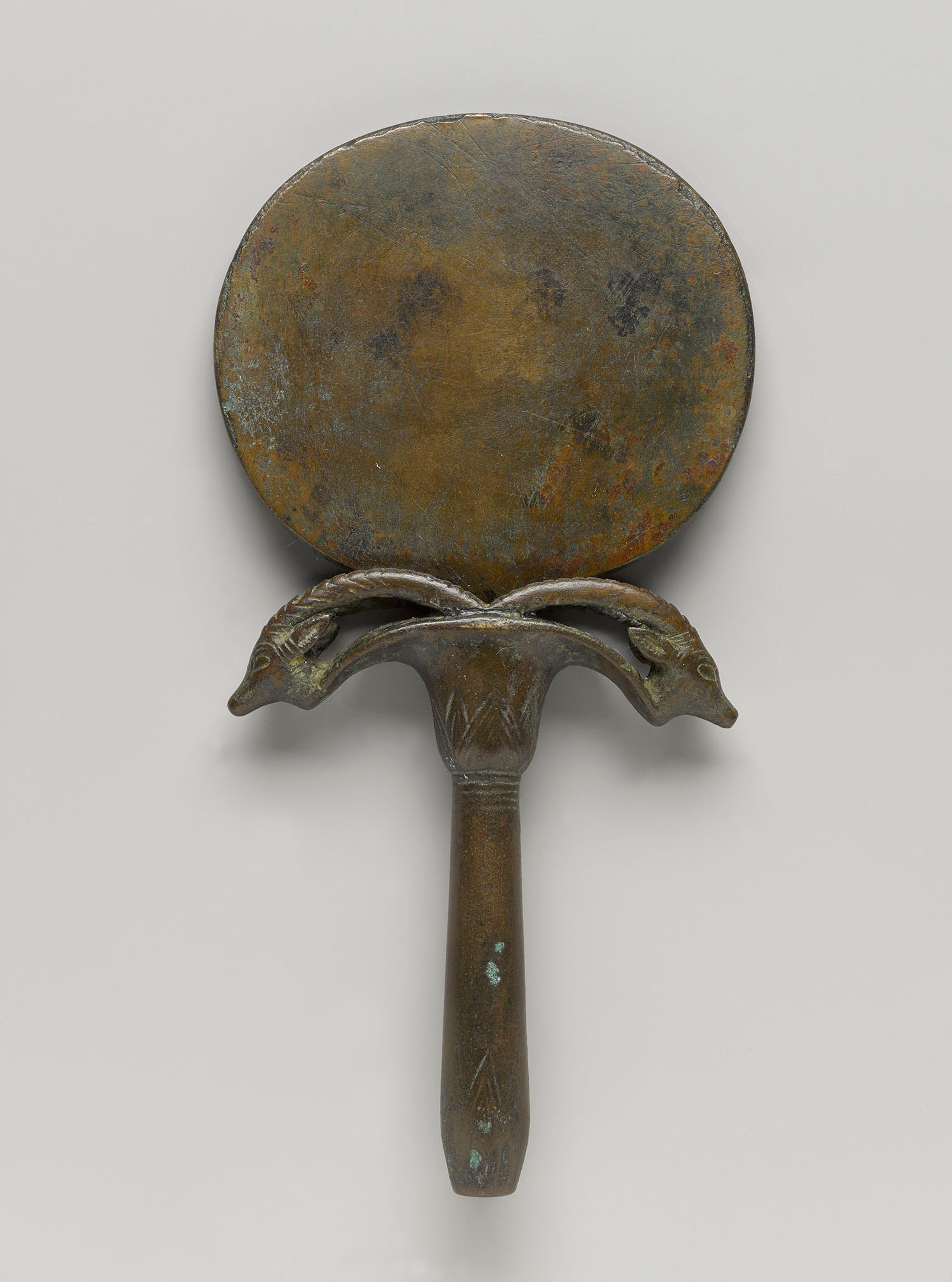 Mirror with Handle in Form of Umbel with Two Ibex Heads, circa 1539–1292 B.C.E. Bronze, Other (handle): 41/4 x 31/2 x 3/4 in. (10.7 x 9 x 2 cm). Charles Edwin Wilbour Fund, 75.168a–b. (Photo: Jonathan Dorado, Brooklyn Museum)