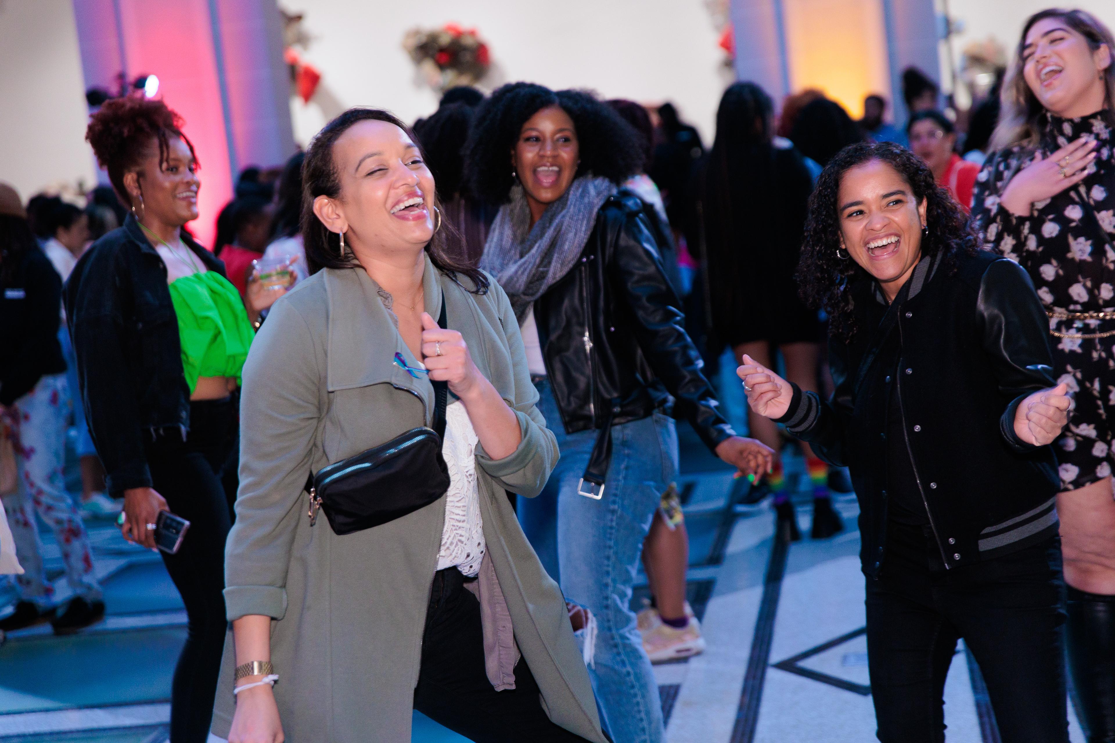 A group of people smiling and dancing