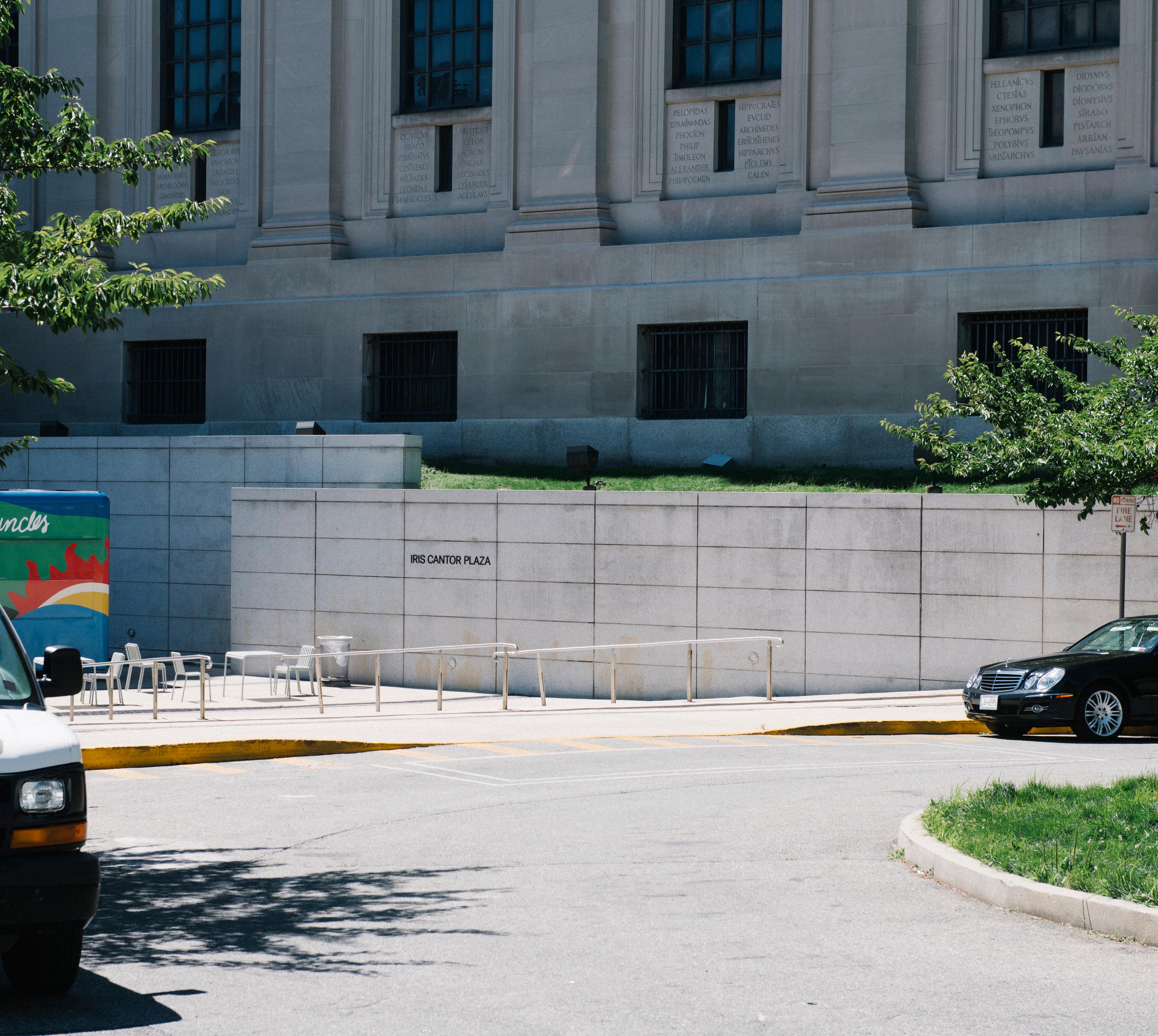 Photo of a building with a drop-off parking driveway with wheelchair accessible ramp and a