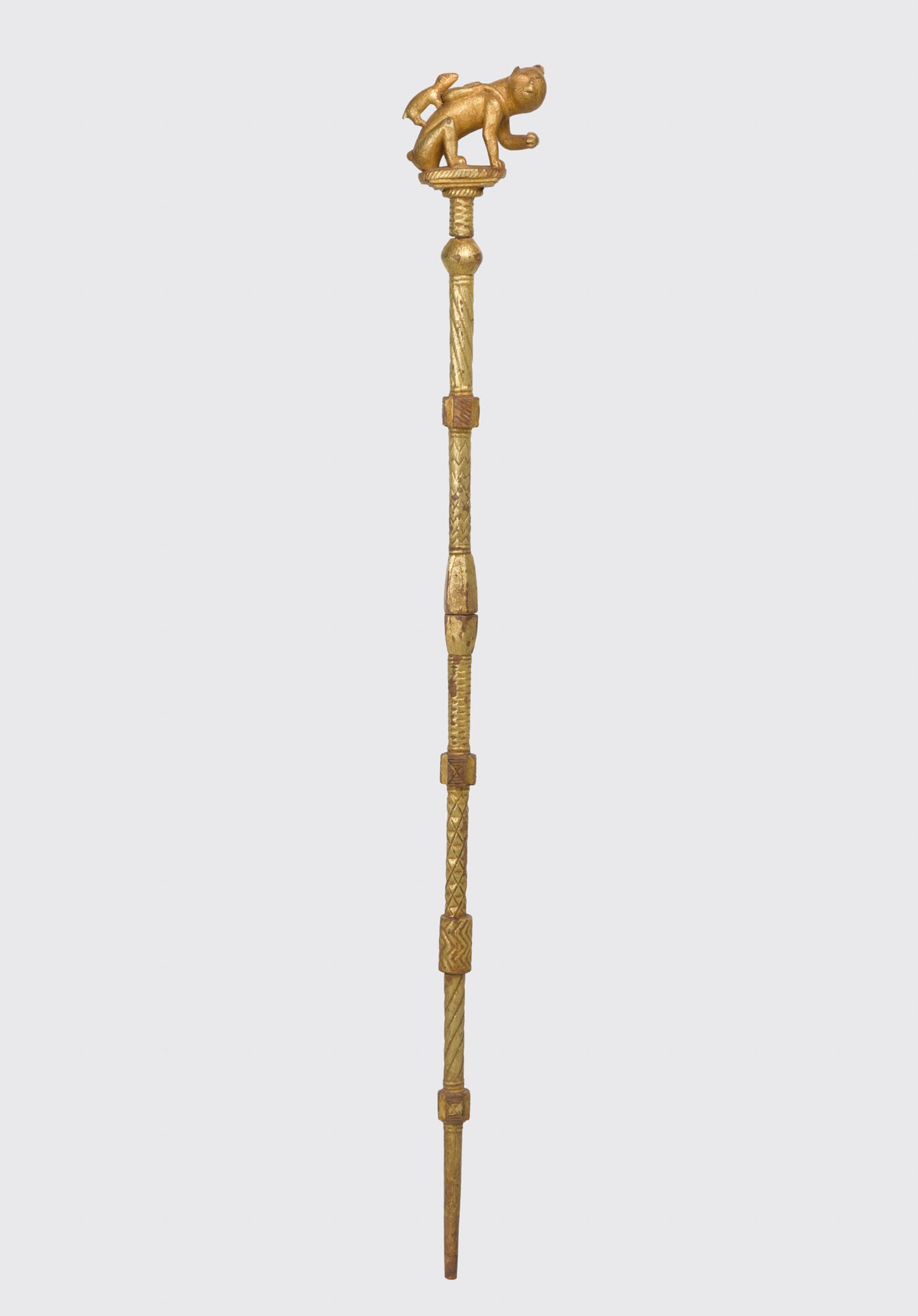 A gold staff topped with animals