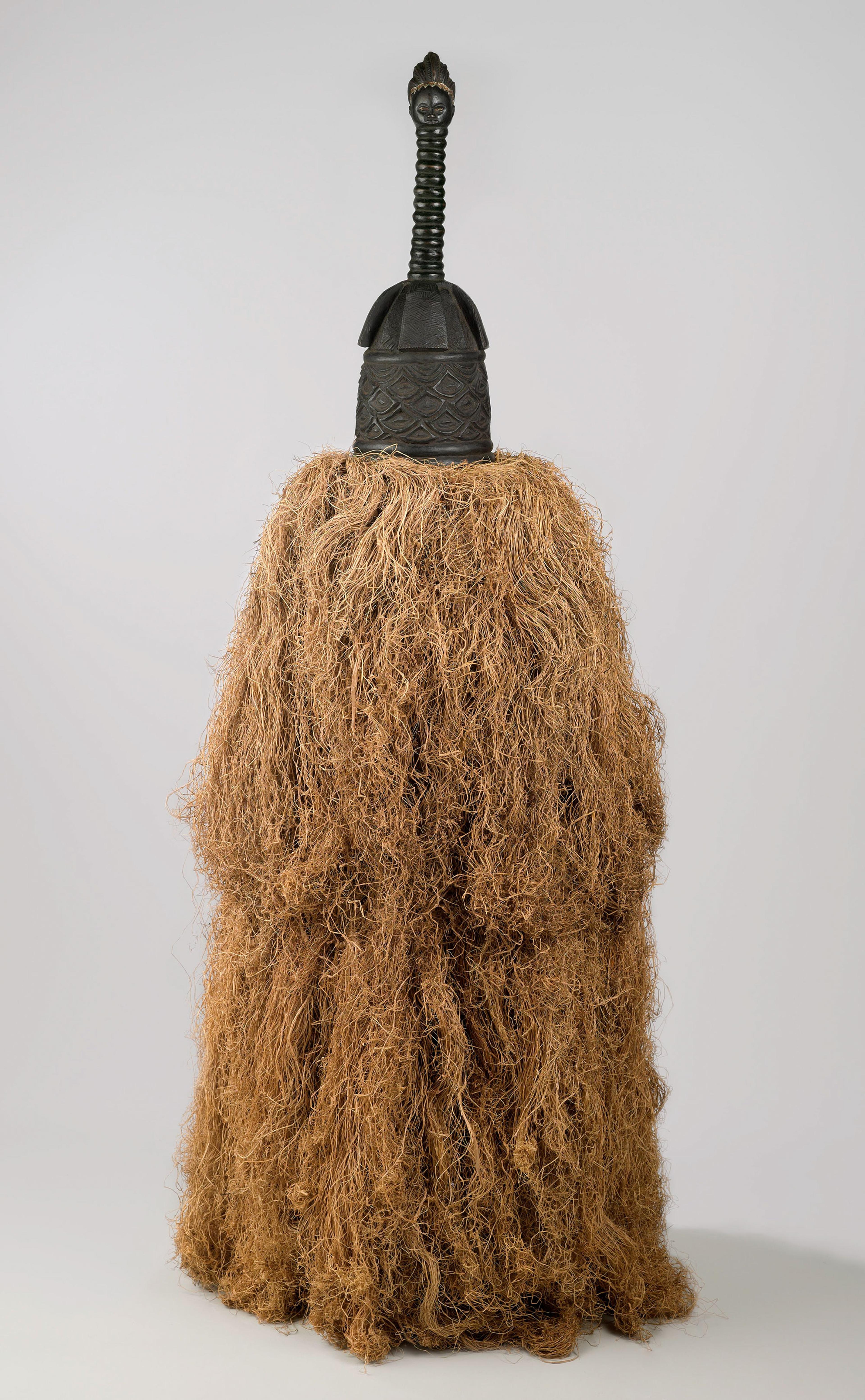 Unidentified Gola artist. Helmet Mask (Gbetu) with Raffia Costume, early to mid-20th century. Grand Cape Mount or Lofa County, Liberia. Wood, pigment, metal, raffia, 93 x 48 in. (236.2 x 121.9 cm). Brooklyn Museum, Gift of William C. Siegmann, 2011.53.1a, b. Creative Commons-BY. Photo: Sarah DeSantis, Brooklyn Museum