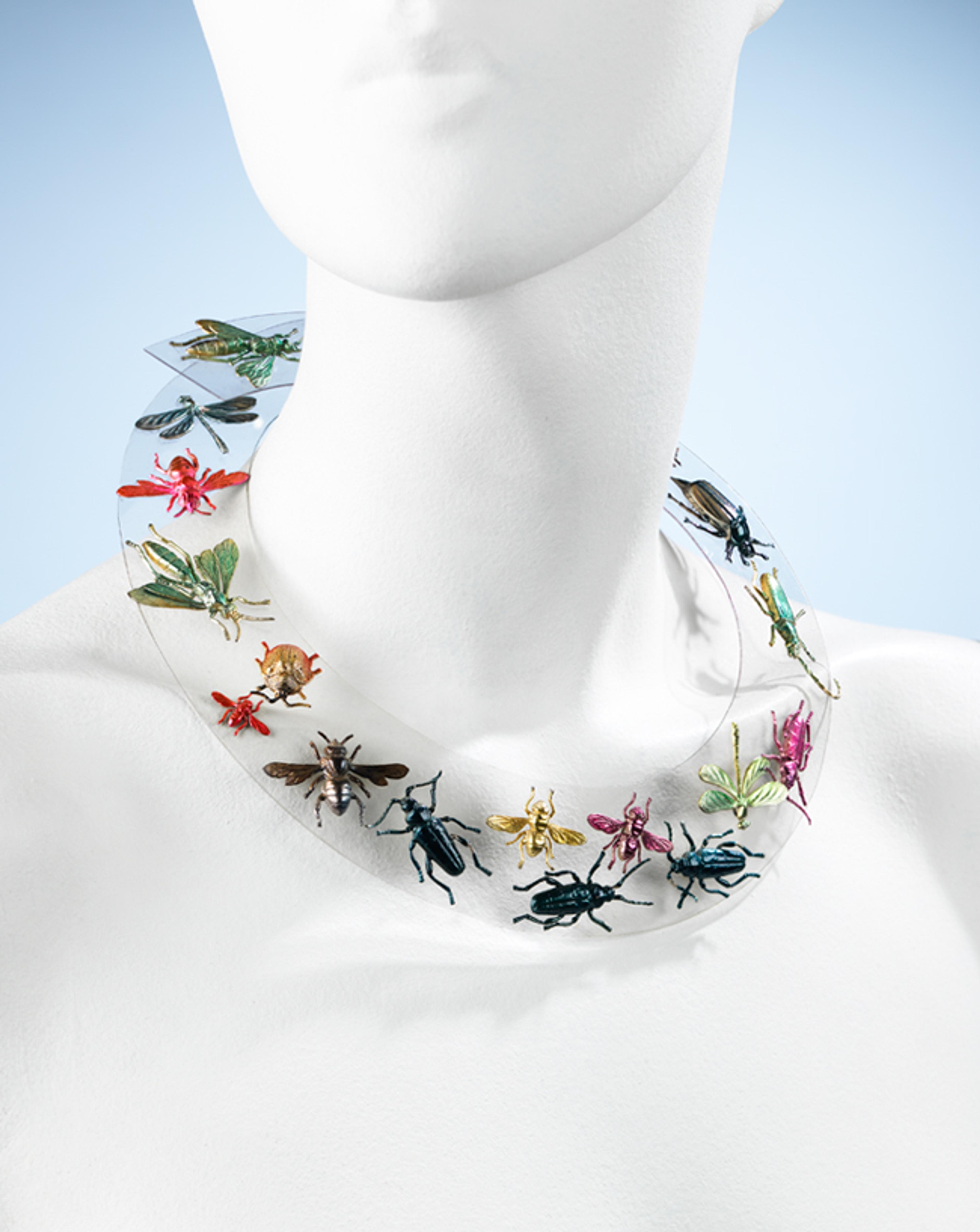 Elsa Schiaparelli (French, born Italy, 1890–1973). Necklace, autumn 1938. Clear Rhodoid (cellulose acetate plastic); metallic green, red, pink, blue, and yellow painted pressed metal ornaments. Brooklyn Museum Costume Collection at The Metropolitan Museum of Art, Gift of the Brooklyn Museum, 2009; Gift of Arturo and Paul Peralta Ramos, 1955 (2009.300.1234)