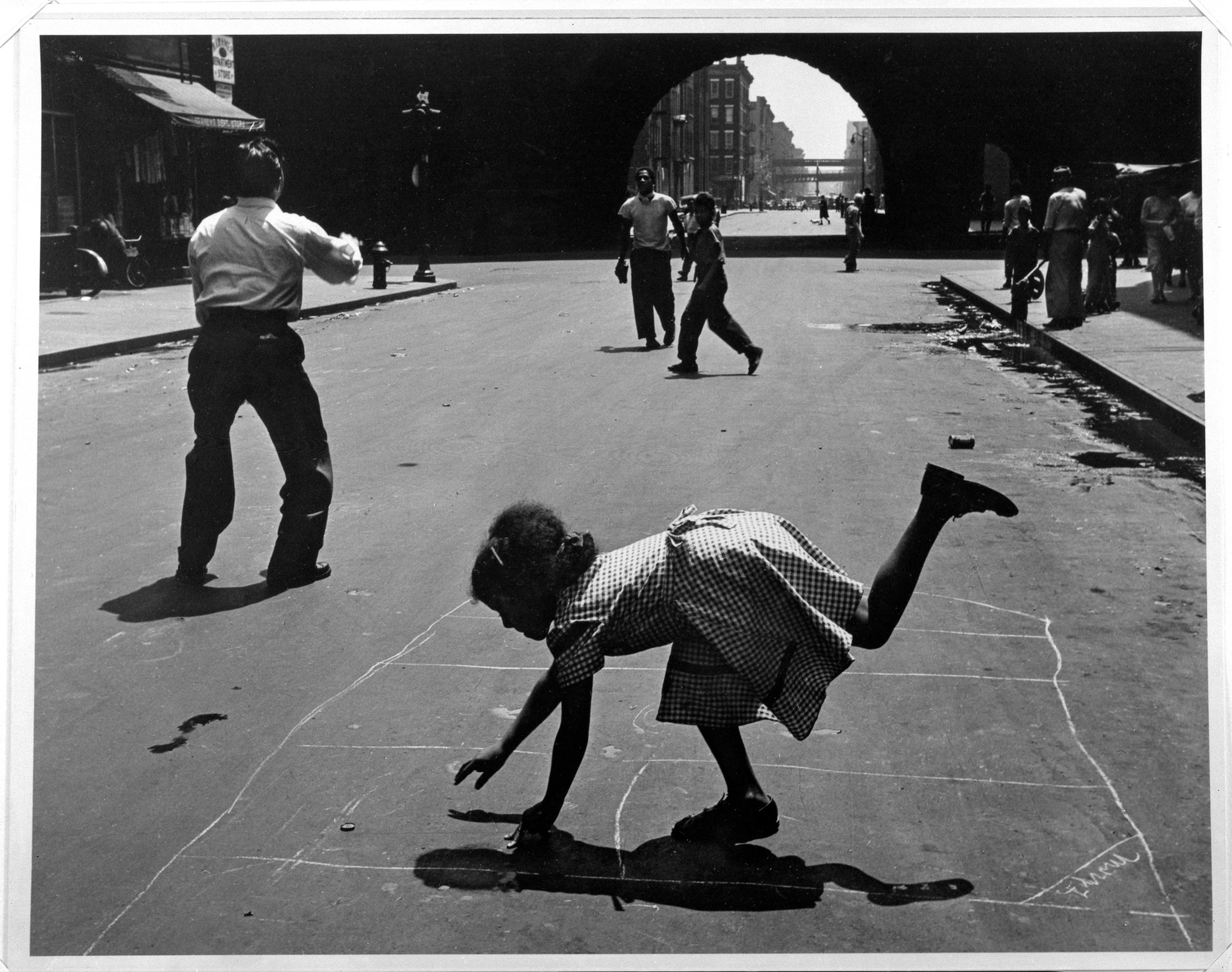 Print showing people playing catch and hopscotch on a city street