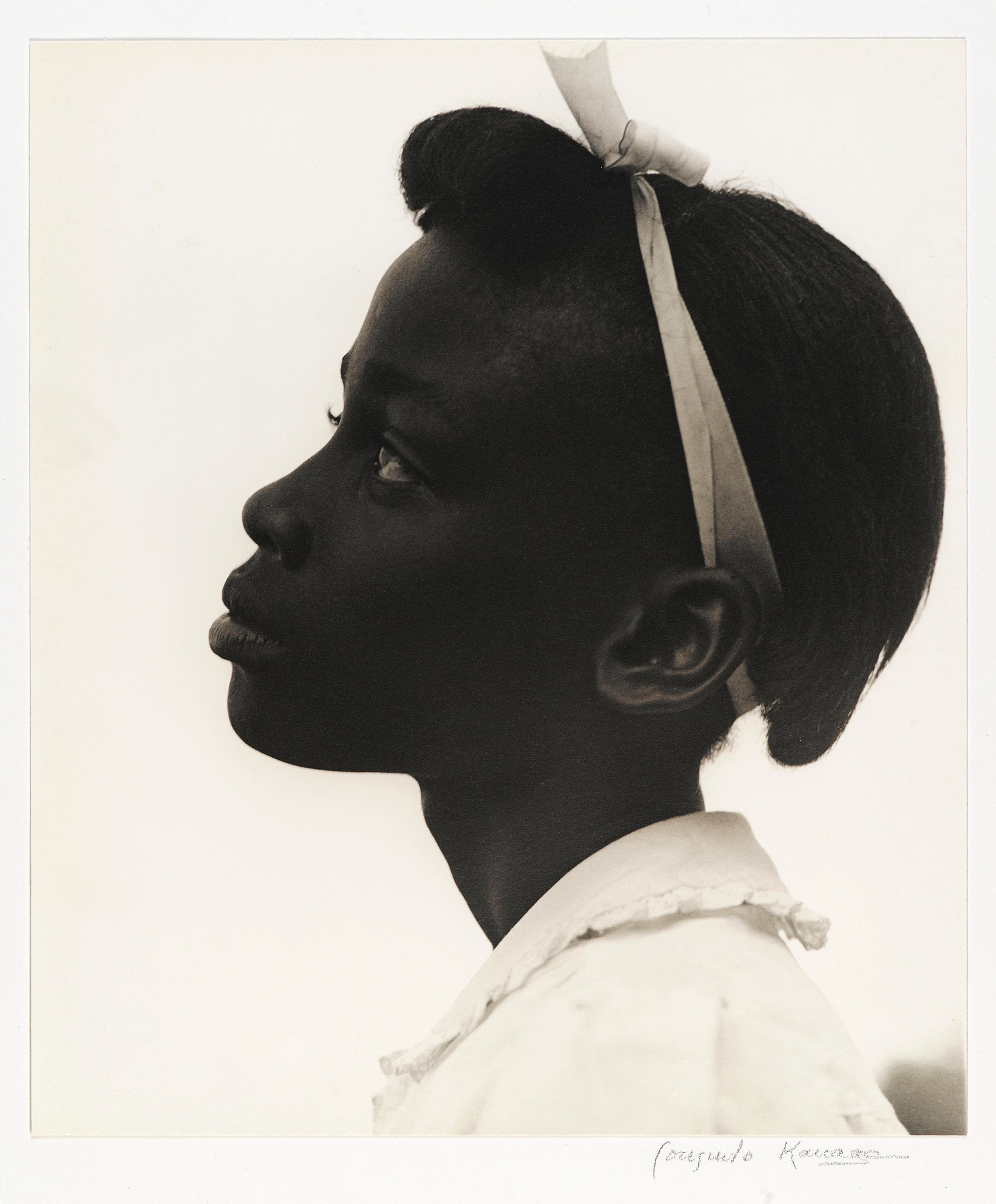 Black-and-white photograph of a young girl in profile