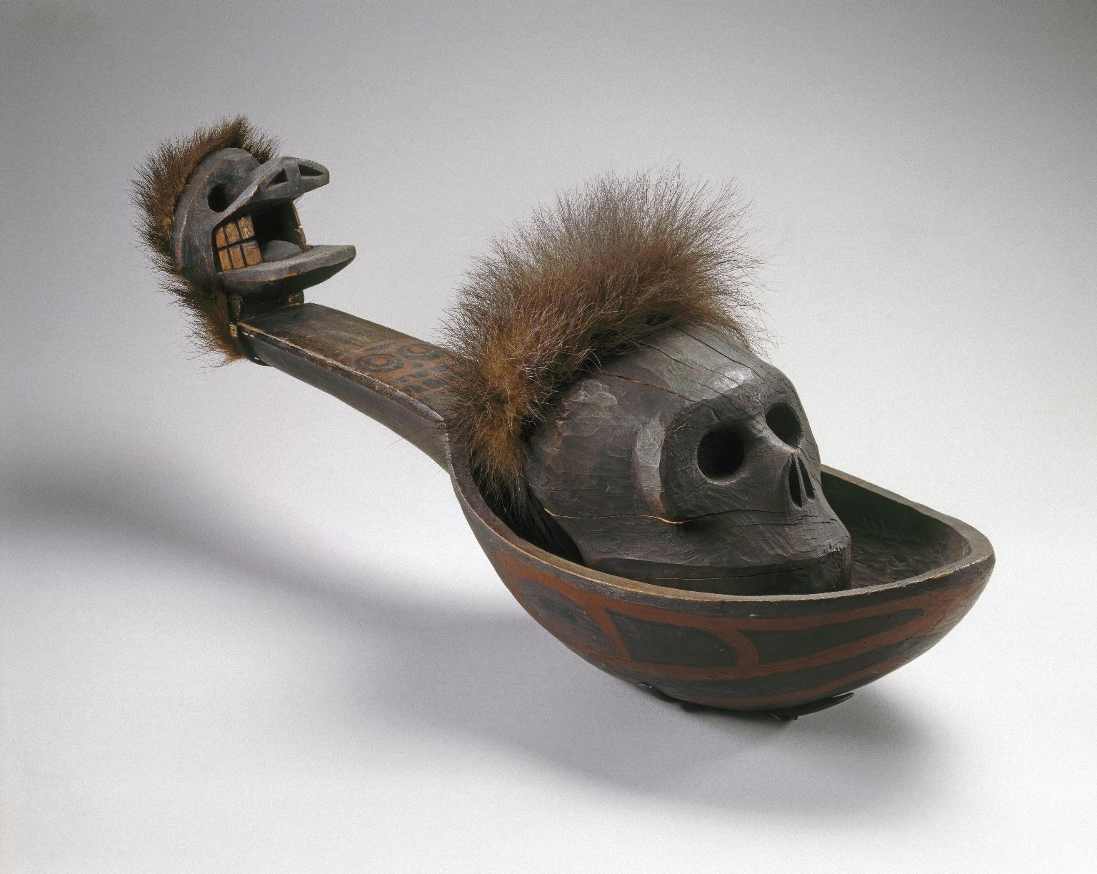 Heiltsuk artist. Ladle with Skull, 19th century. Wáglísla, British Columbia, Canada. Cedar wood, bear fur, cord, pigment, 29 × 83⁄4 x 95⁄16 in. (73.7 × 22.2 × 23.6 cm). Brooklyn Museum, Museum Expedition 1905, Museum Collection Fund, 05.588.7297a–b