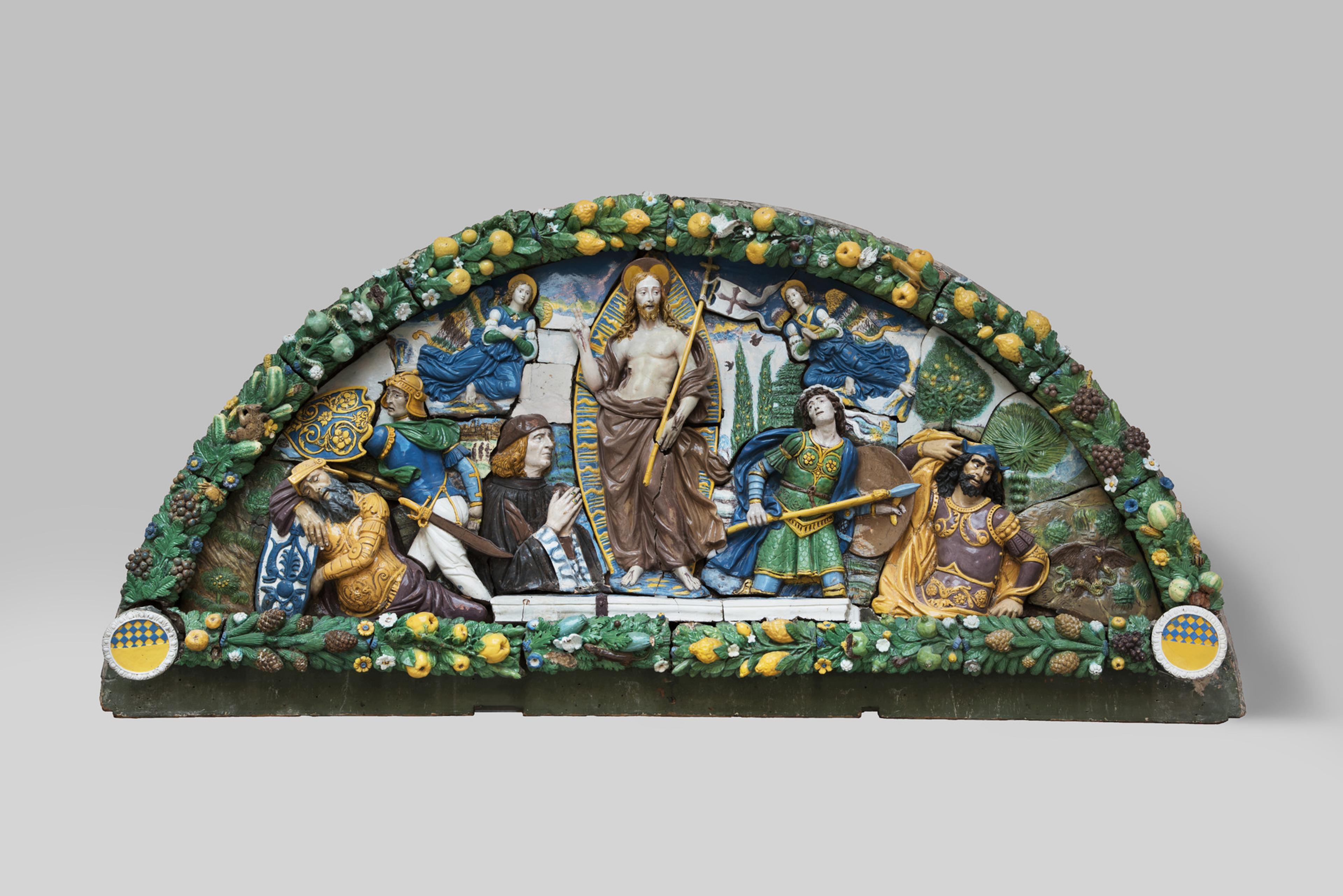 A colorful relief depicting a religious scene, surrounded by a vibrant border of fruits, flowers, and foliage