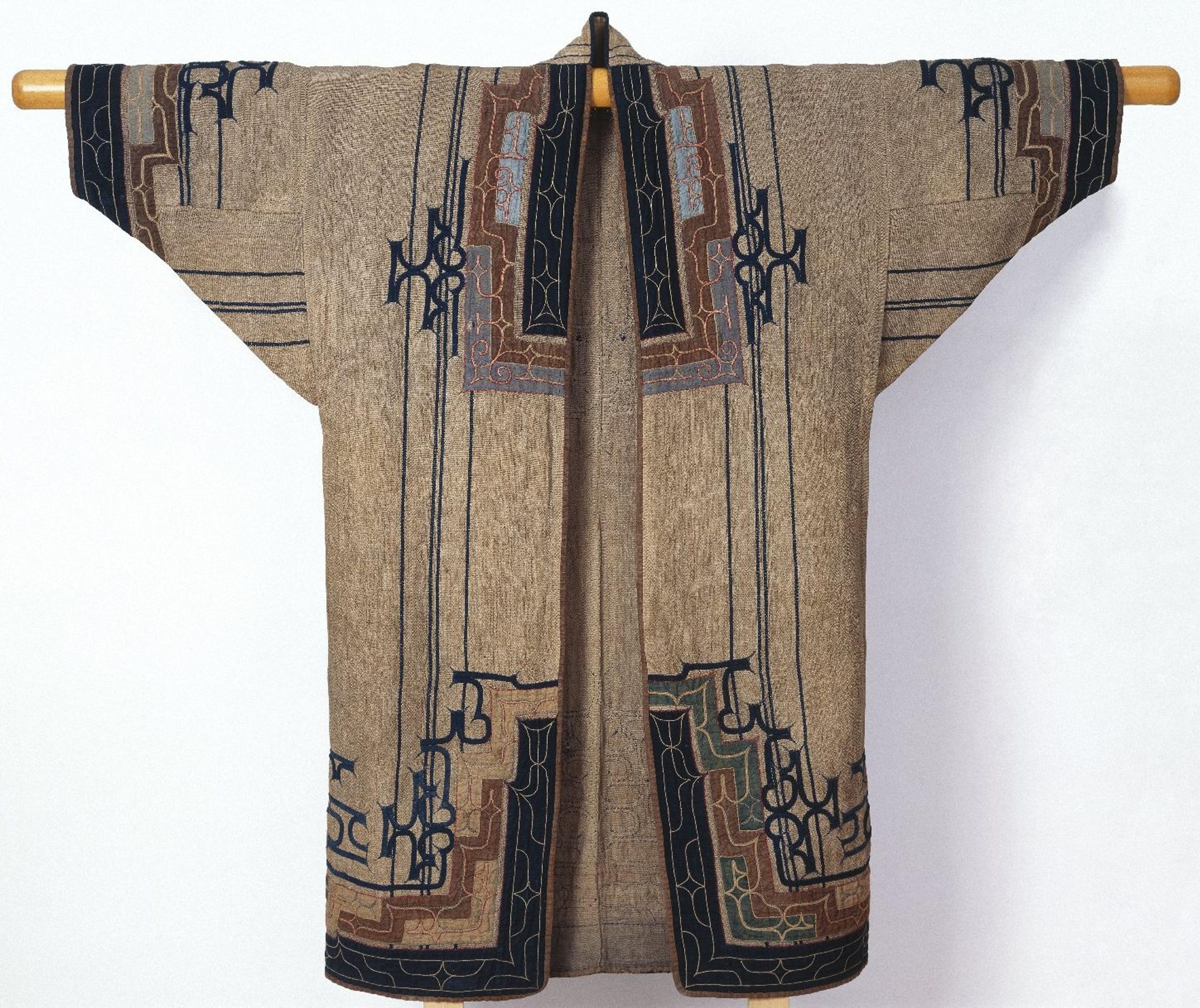 Woman's Robe. Japan, Ainu people, late 19th–early 20th century. Elm bark fiber cloth (attush) with appliqué and embroidery, 49 5/8 × 52 3/8 in. (126 × 133 cm). Brooklyn Museum; Gift of Herman Stutzer, 12.690. Creative Commons-BY. (Photo: Brooklyn Museum)