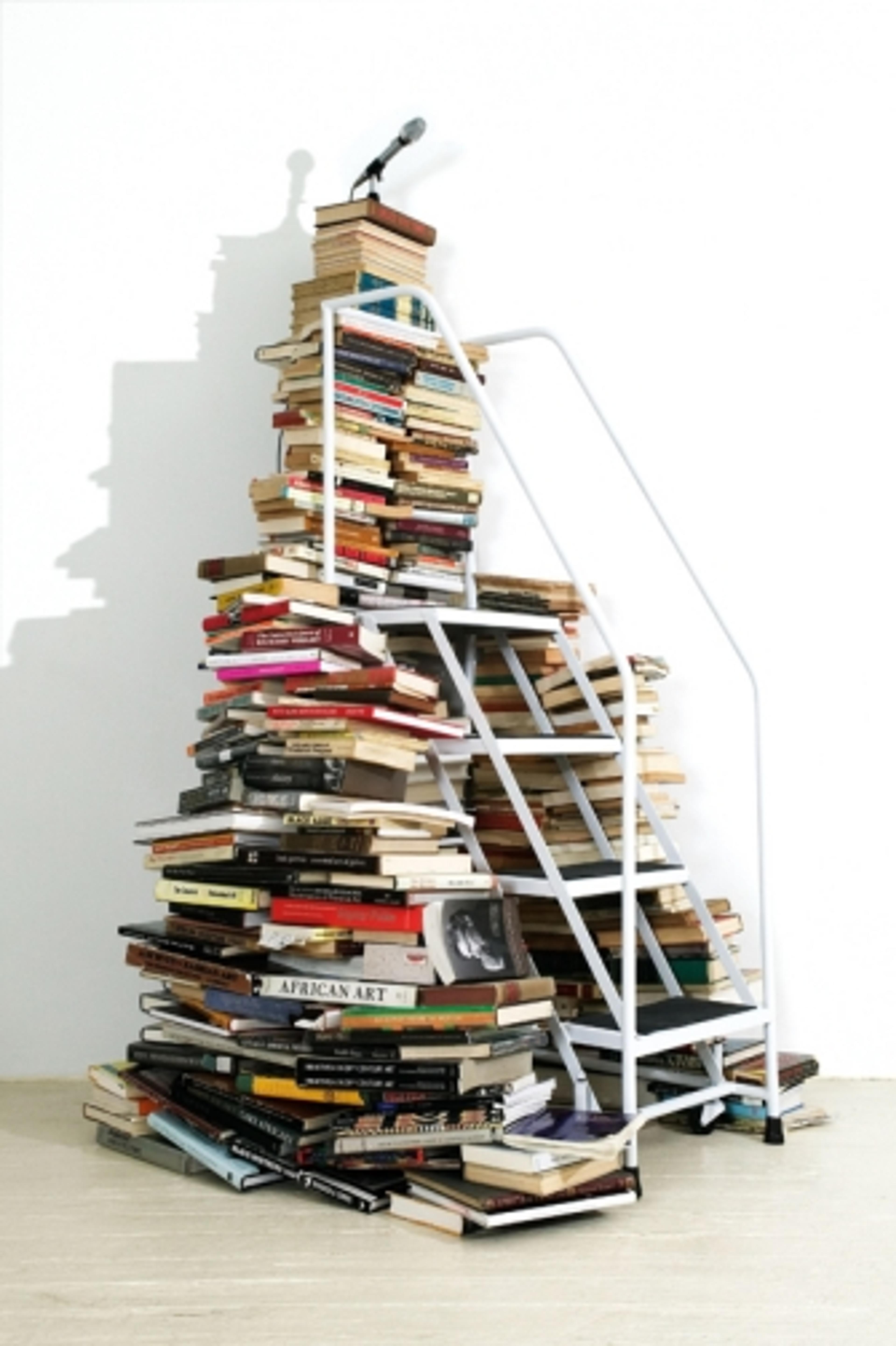 Satch Hoyt (b. United Kingdom 1957; works in United States). Say It Loud!, 2004. Five hundred books, white metal staircase, and microphone with four speakers, wall text; dimensions variable. Courtesy of the artist