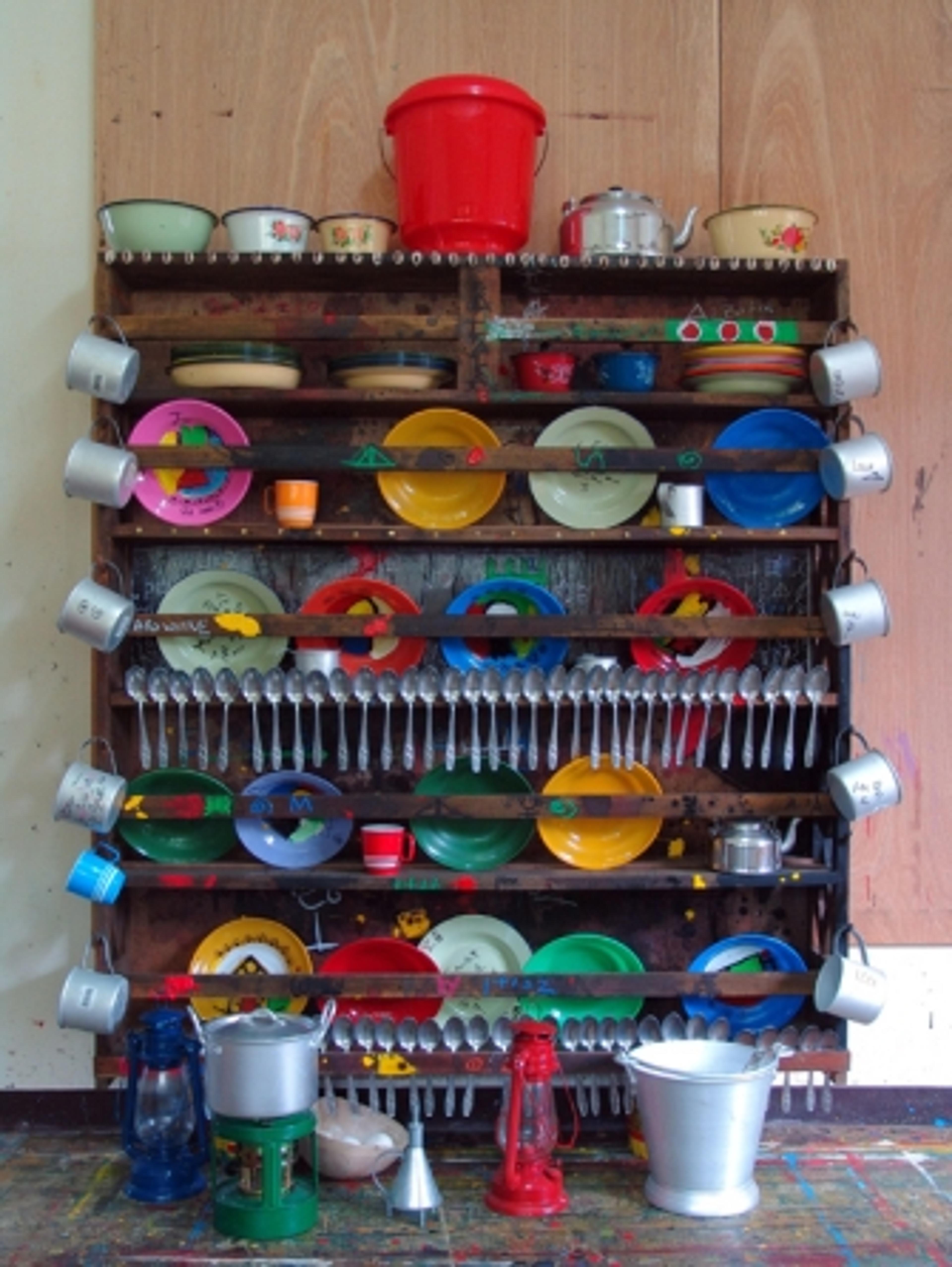 Marcel Pinas (b. Suriname 1971). Kuku (Kitchen), 2005. Plastic plates, aluminum spoons, cups, wood shelves; 59 × 59 × 85⁄8 in. (150 × 150 × 22 cm). Courtesy of the artist