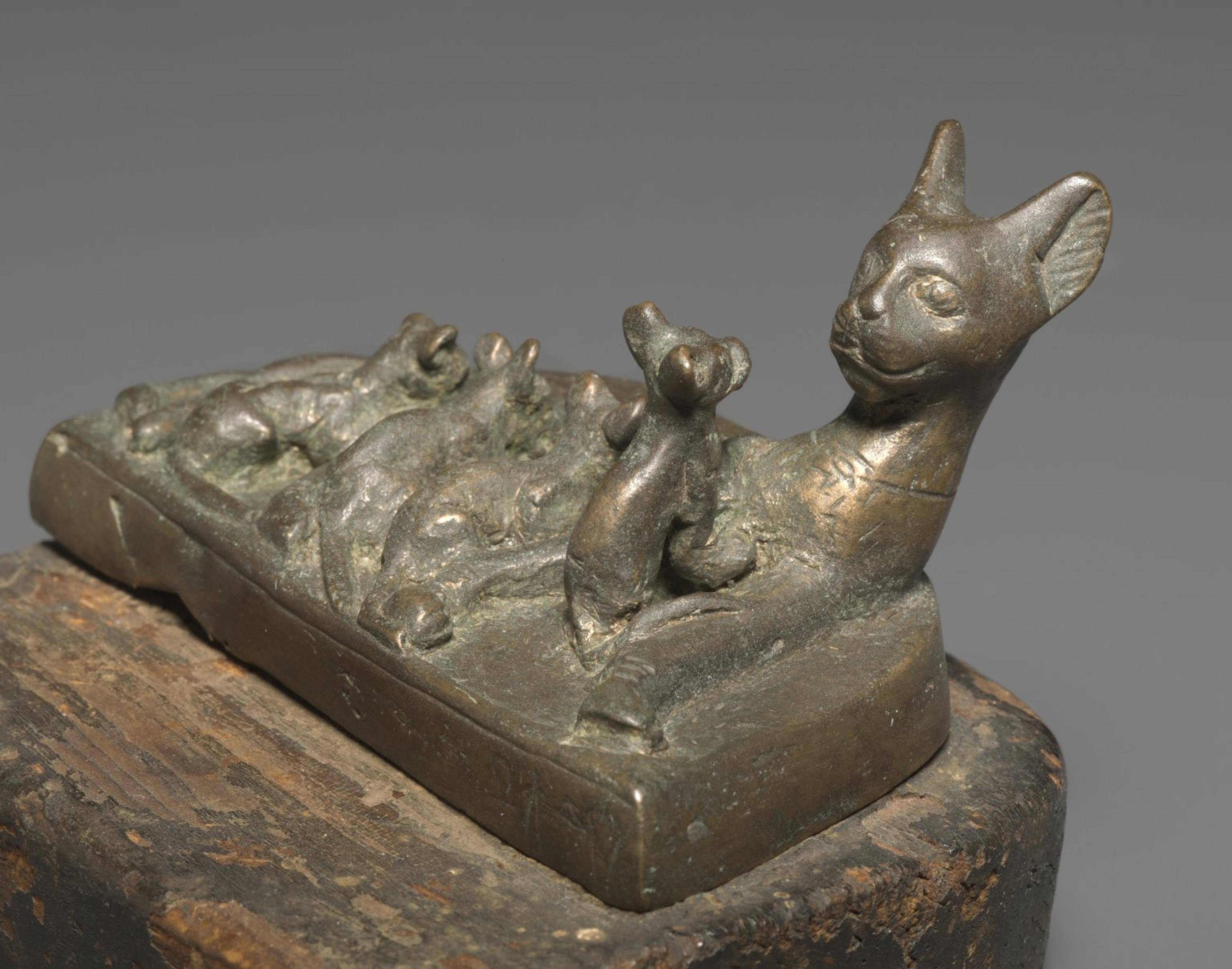 Cat with Kittens (detail). Reportedly from Saqqara, Egypt. Late Period to Ptolemaic Period, Dynasty 26 or later, circa 664–30 B.C.E. Bronze, solid-cast and wood, 23⁄8 x 37⁄16 x 115⁄16 in. (6.1 × 8.8 × 5 cm). Brooklyn Museum, Charles Edwin Wilbour Fund, 37.406E