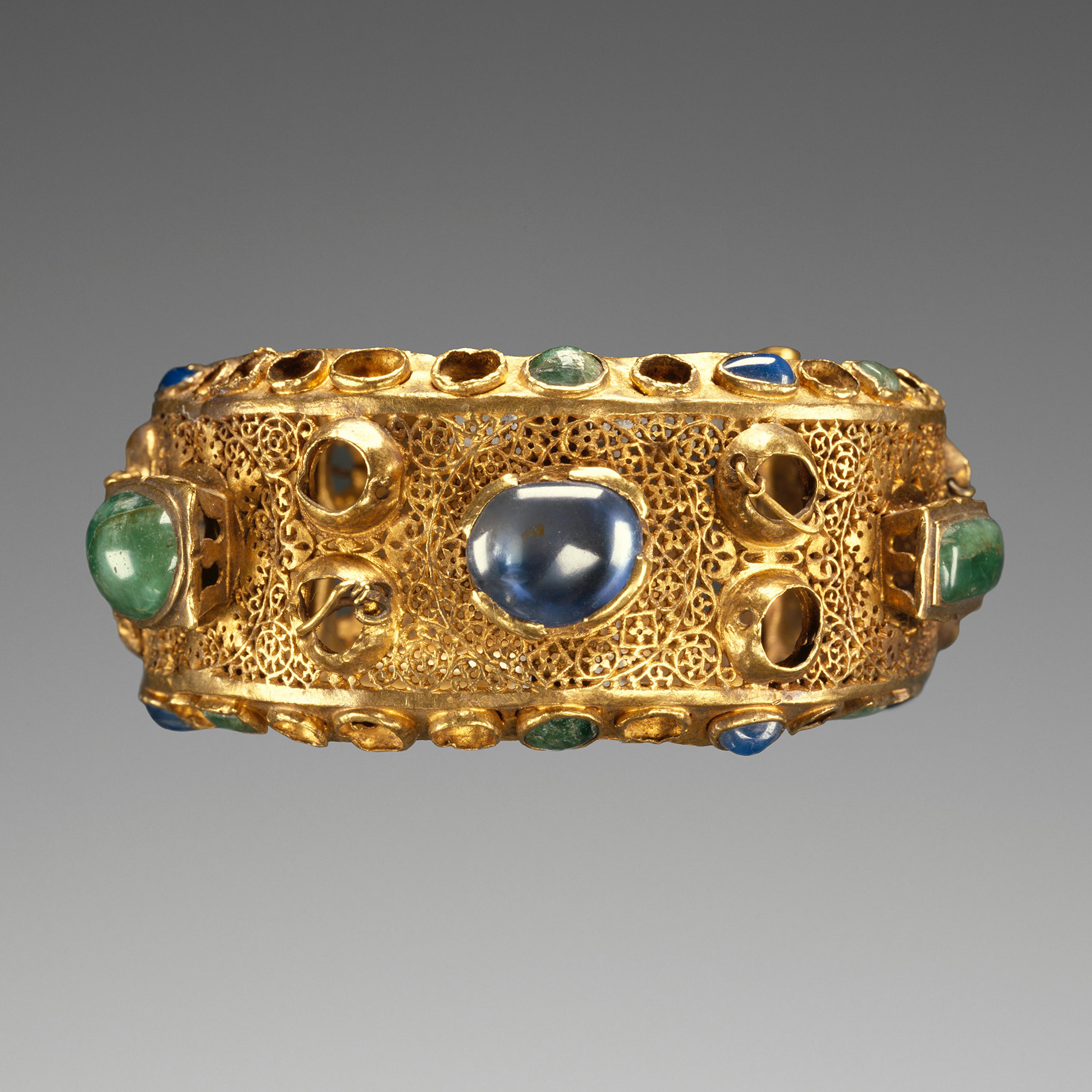 A gold bracelet embedded with jewels