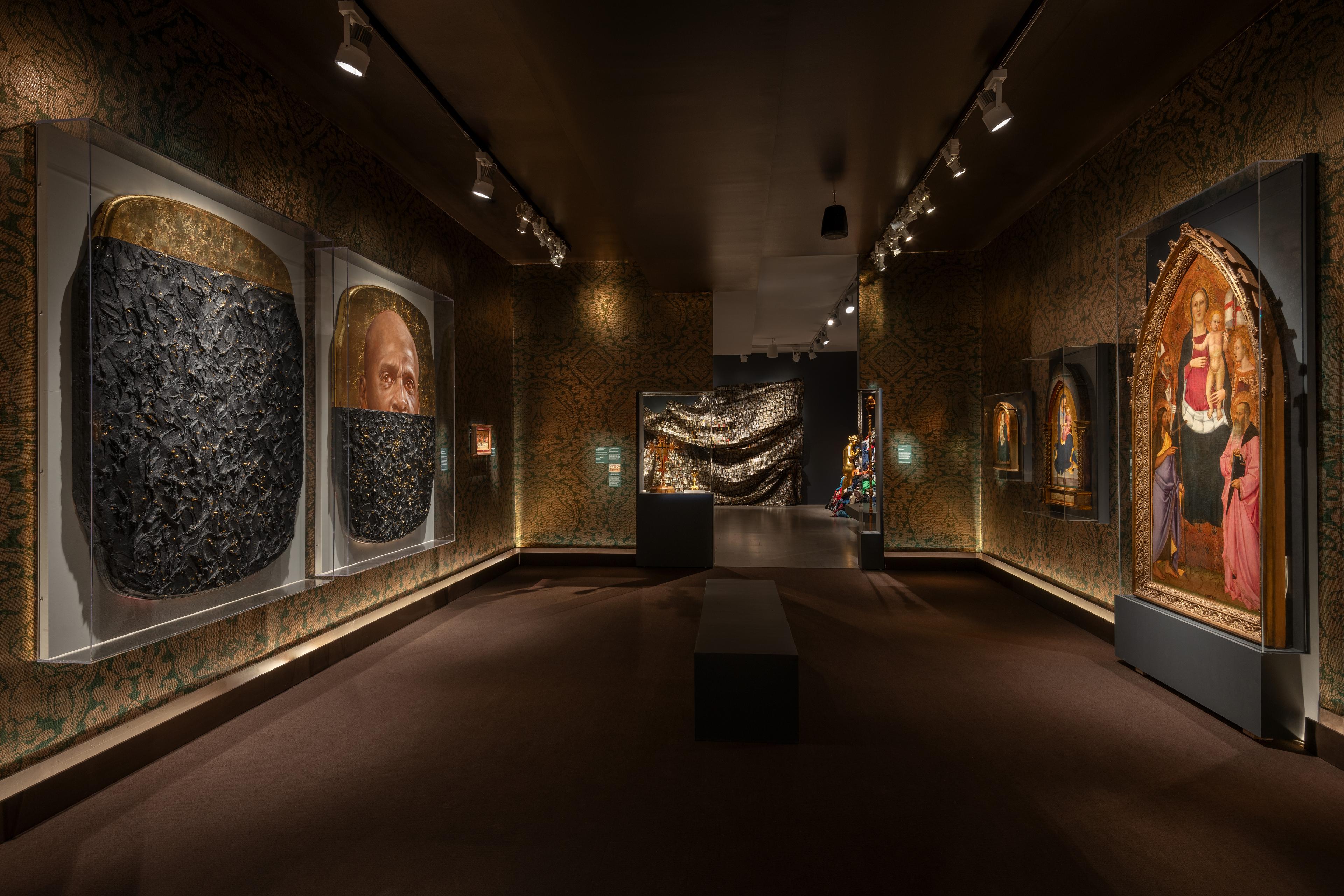 A view of a Solid Gold gallery lined with large artworks