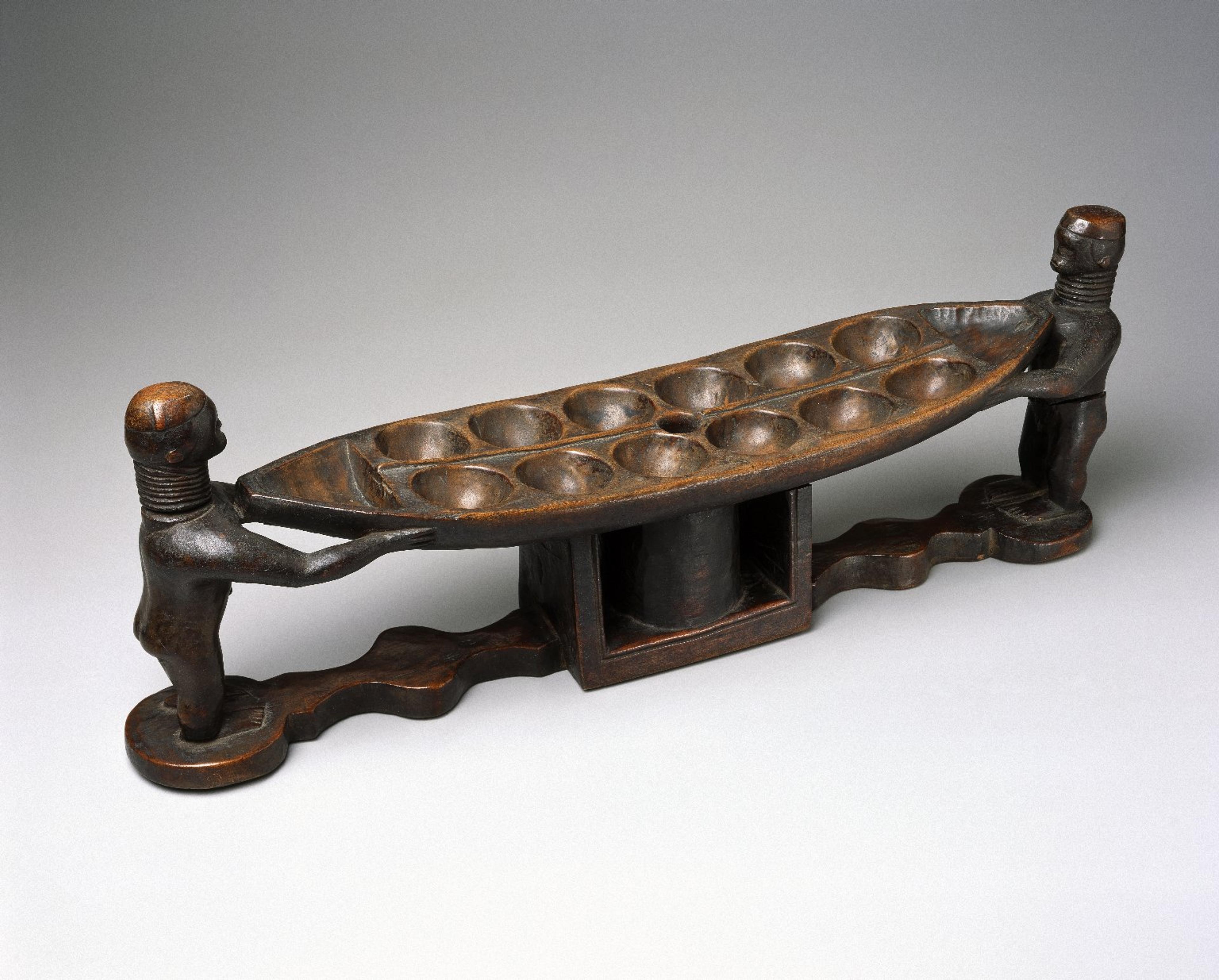 Possibly Bullom. <i>Mancala Game Board</i>, 19th century. Wood, 8 1/4 x 23 1/4 x 5 1/8 in. (21 x 59.1 x 13 cm). Brooklyn Museum, Museum Expedition 1922, Robert B. Woodward Memorial Fund, 22.239. Creative Commons-BY (Photo: Brooklyn Museum)