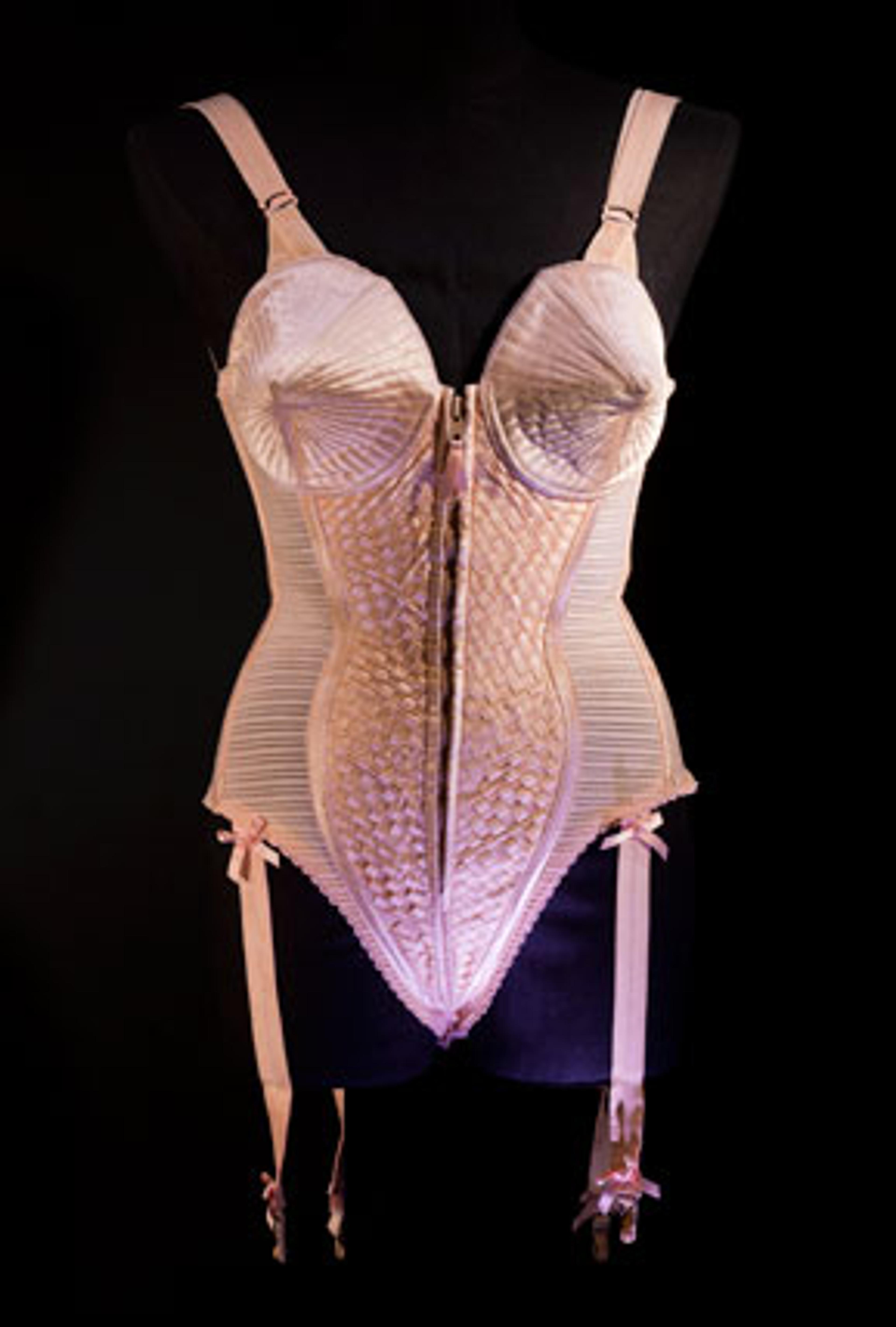 Jean Paul Gaultier (French, b. 1952). Corset-style body suit with garters, 1990, Duchess satin. Worn by Madonna during the “Metropolis” (“Express Yourself”) sequence of the Blond Ambition World Tour (1990). Collection of Madonna, New York. (Photo: The Montreal Museum of Fine Arts, Christine Guest)